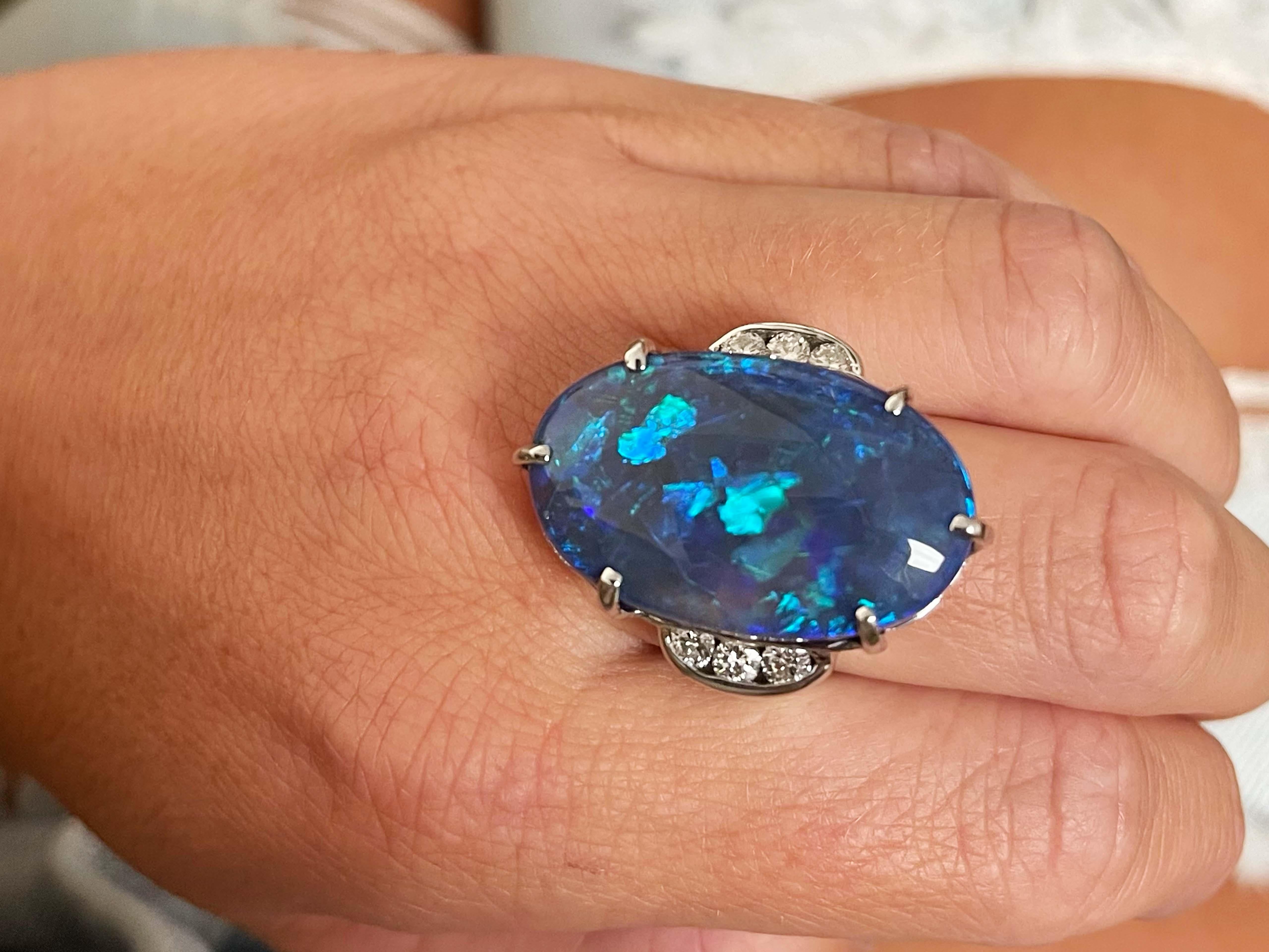 Item Specifications:

Metal: 18K White Gold 

Style: Opal and Diamond Ring

Total Weight: 23.90 Grams

Gemstone Specifications:

Center Gemstone: Australian Lightning Ridge Black Opal

Gemstone Measurements: 28 mm x 17.9 mm x 9.95 mm

Gemstone Carat