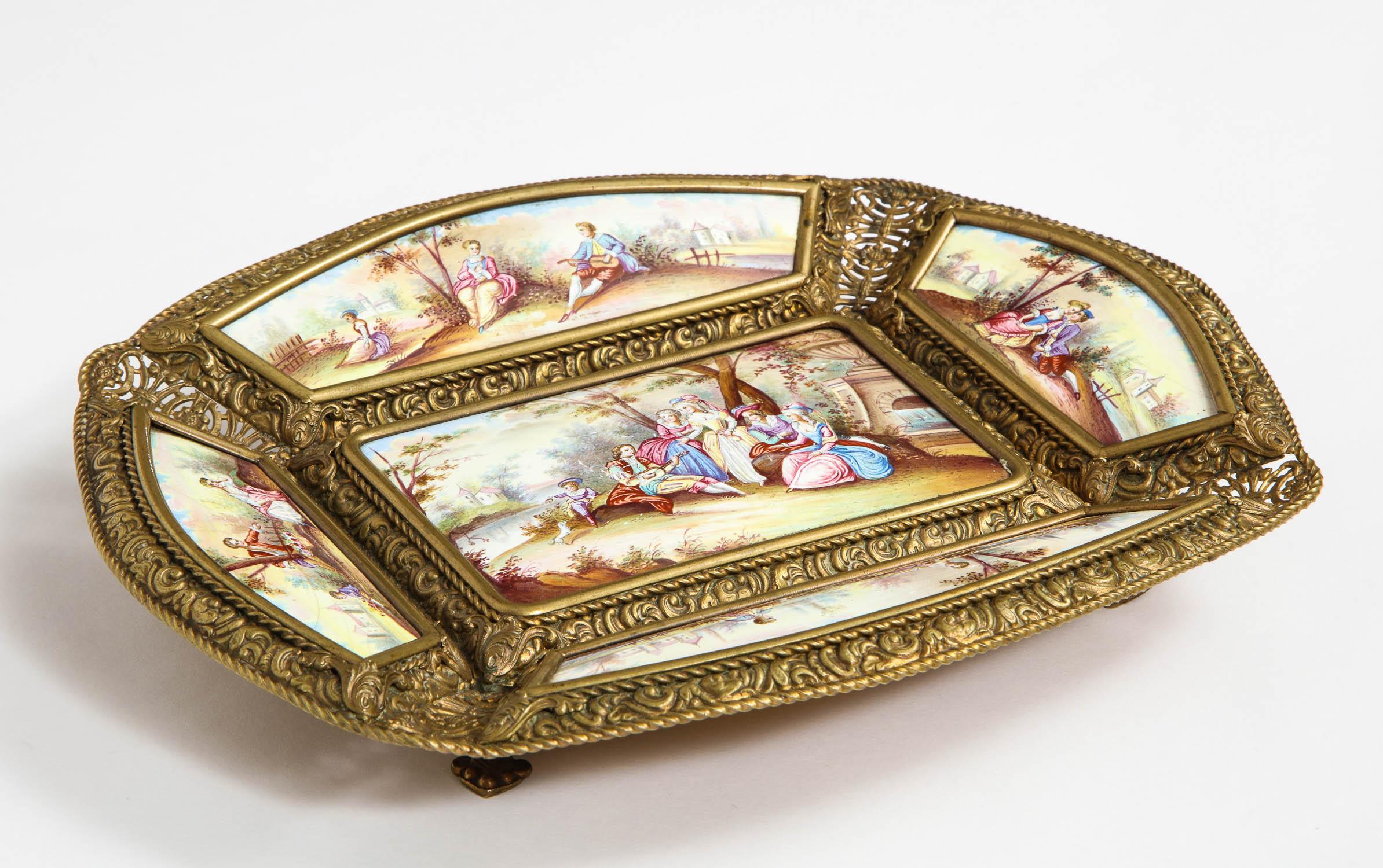 A large Austrian hand painted Viennese enamel-mounted gilt-metal tray,
circa 1890.

Very large and very fine quality paintings on a gilt-metal footed base.

Hairlines in some areas of enameling around the borders. Minor scratches to the center