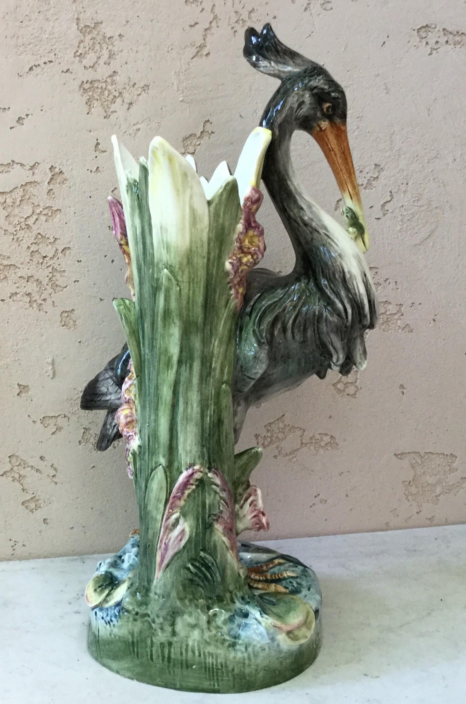 Large 19th century Austrian Majolica heron with a lizard on his beek, the vase on the back of the heron is decorated with aquatics plants and pink flowers.