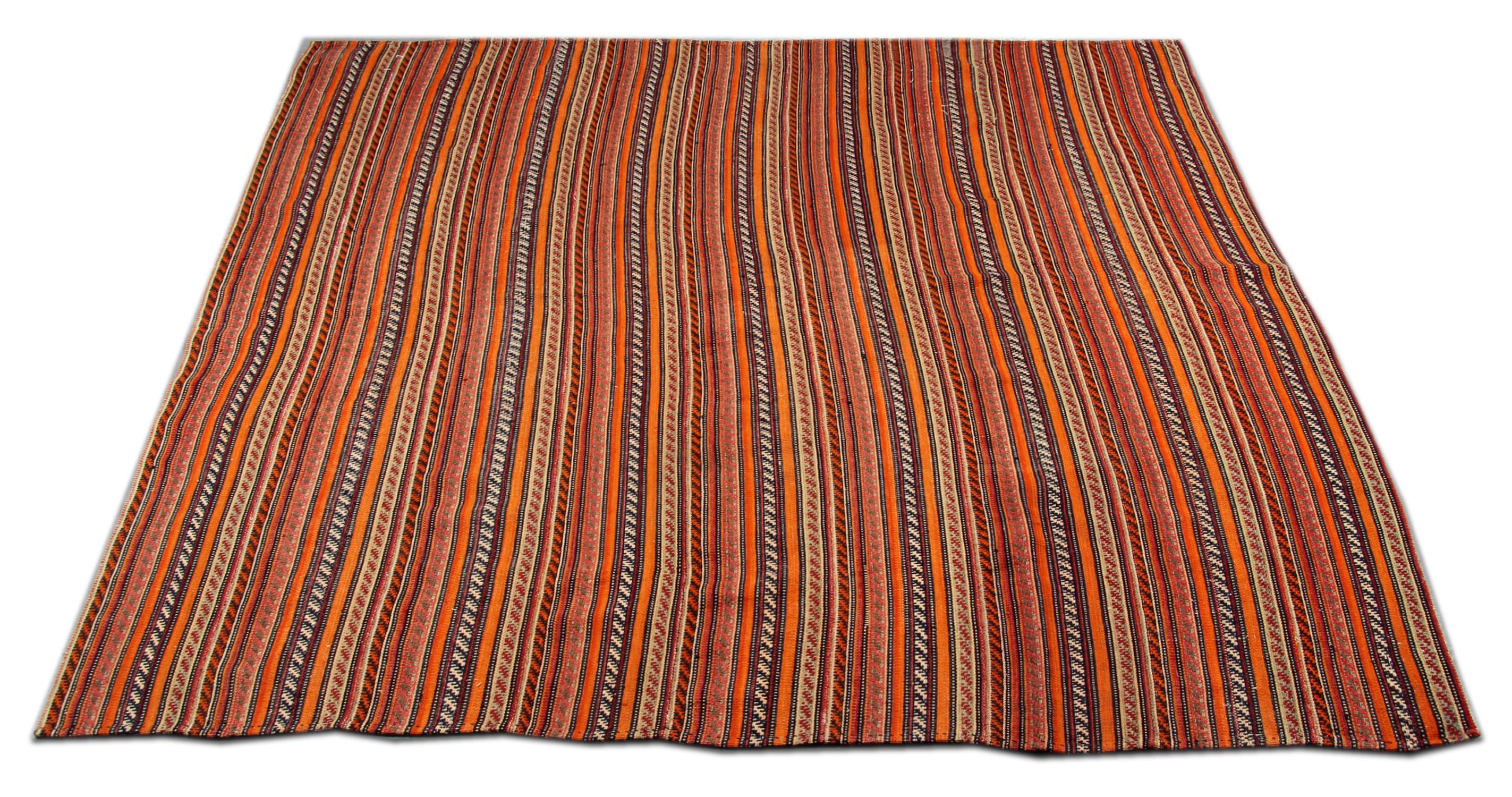 Orange, red and black make up the simple geometric stripe design in this Jajim, woven by hand in Azerbaijan. The traditional stripe design and the simple color palette in this piece make it suitable for any home interior.
Constructed with Fine,