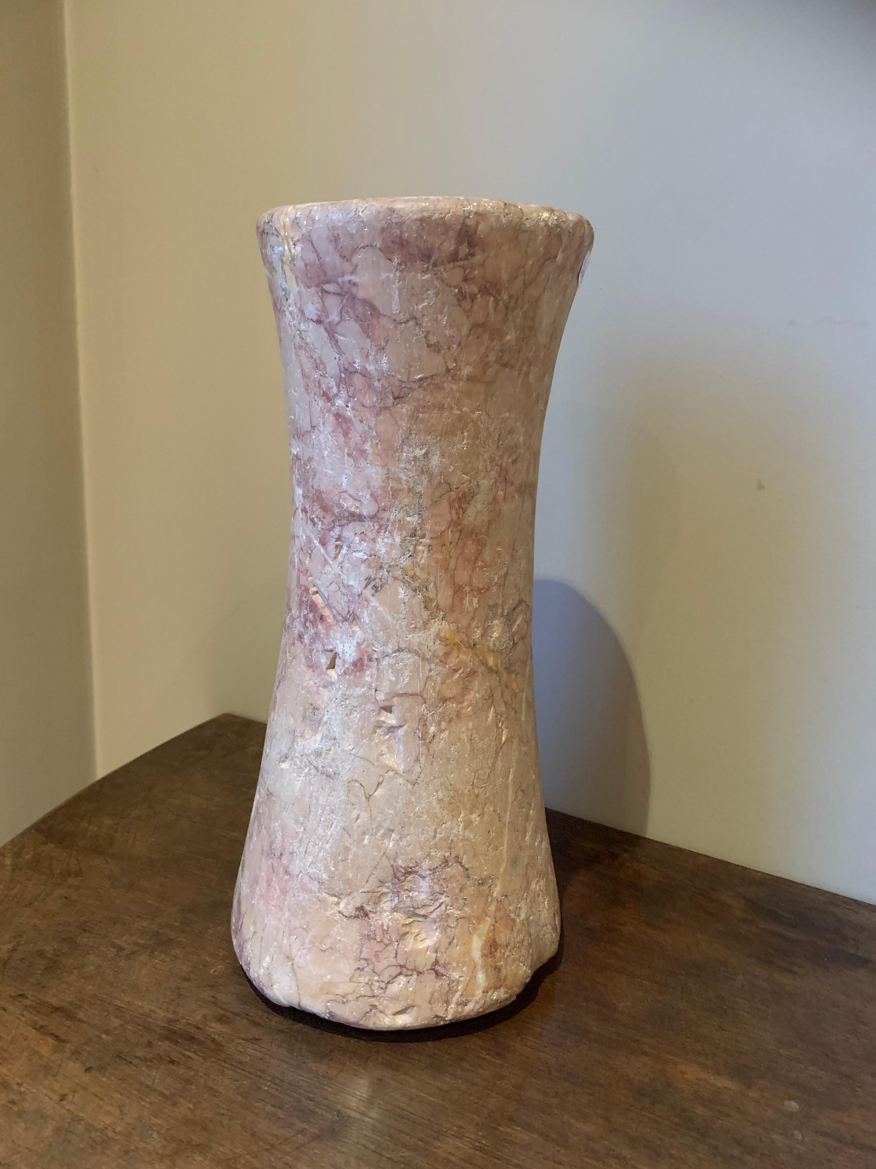 Bactrian marble column idol, circa 3000-2000 BC. It has a elegant tapering form with a undeep groove running on the top. The marble is strikingly vained in a cream pink read color. It has incrustation on the side where it laid on the sand and the