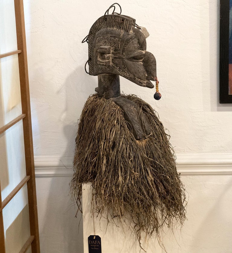 This expressive Baga Nimba headdress or mask was worn on top of woman's head with the raffia and adding clothing were concealing the body. The use of these masks was dancing at fertility ceremonies. This particular mask is made for decorative