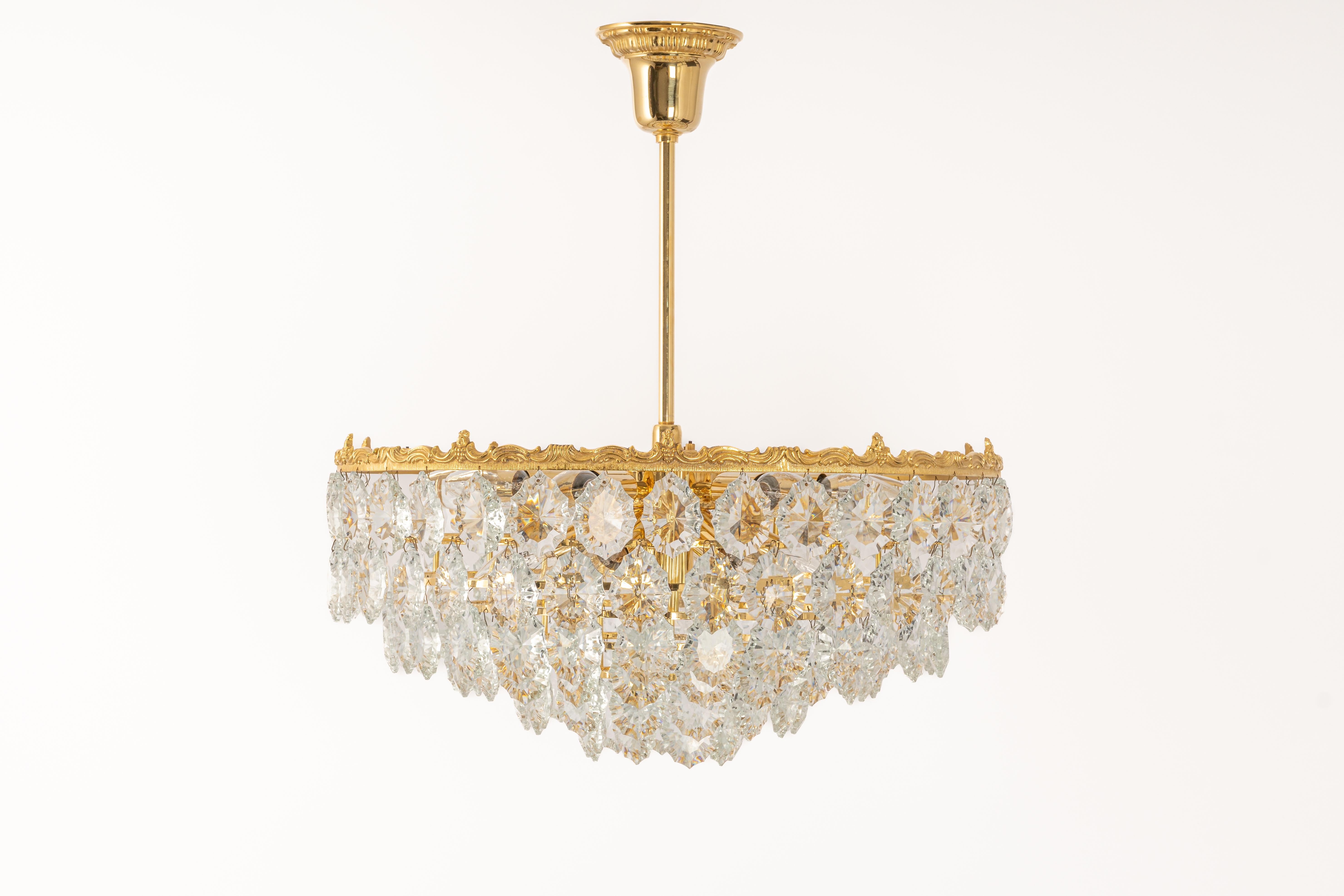 A stunning six-tier chandelier by Bakalowits & Sohne, Austria, manufactured in circa 1960-1969. A handmade and high-quality piece. The ceiling fixture and the frame are made of gilt brass and have six rings with lots of facetted crystal glass