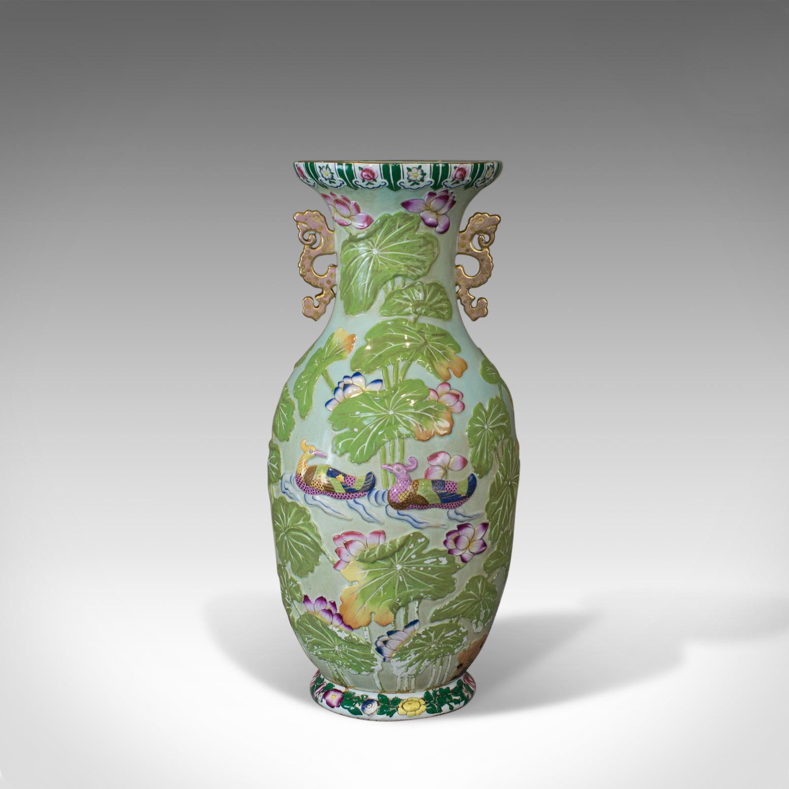 This is a large vintage baluster vase. An Oriental ceramic urn with floral and foliate decoration dating to the mid-late 20th century.

Of classic form and in good proportion
Of quality craftsmanship, free from damage
Unmarked base displays some