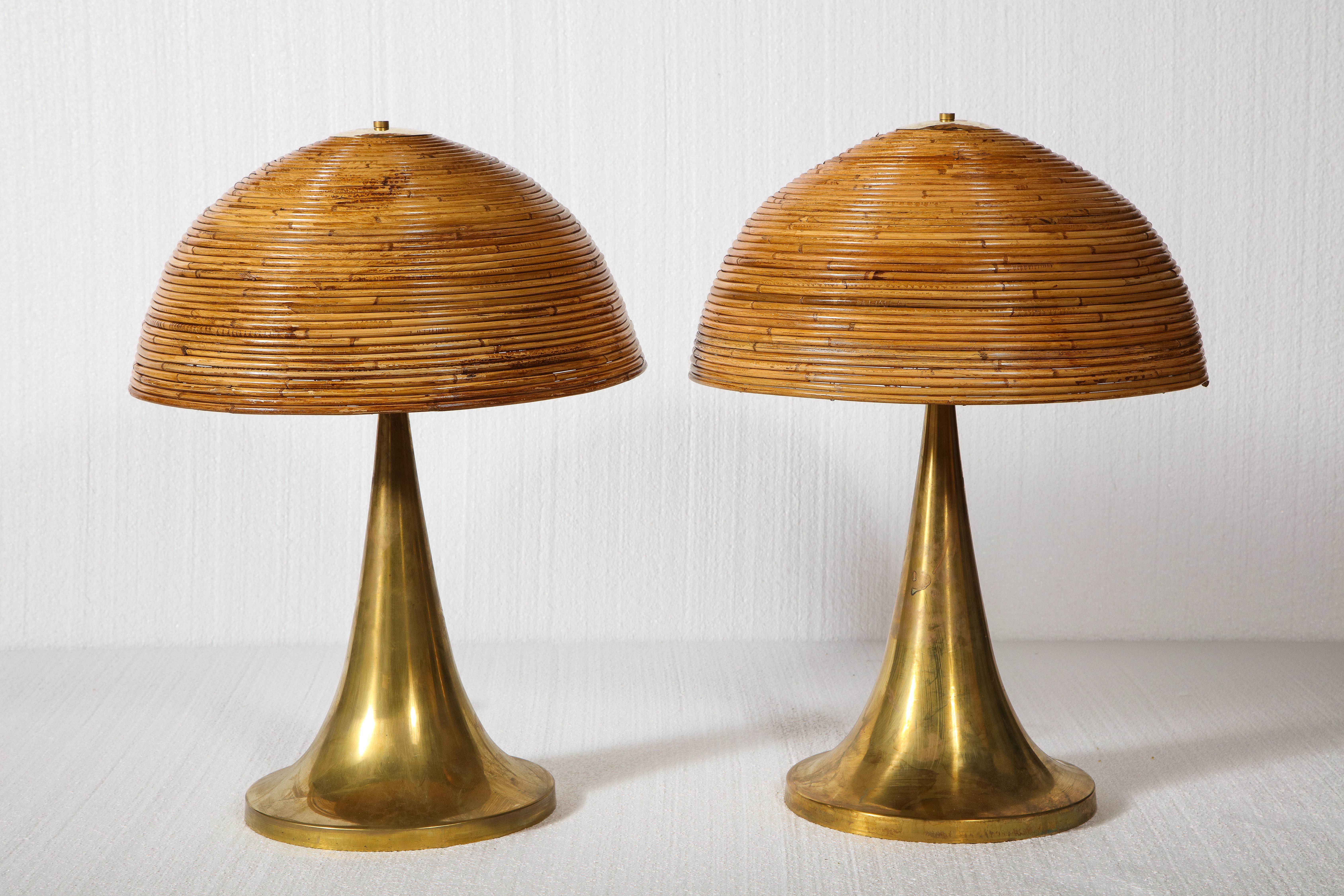 large bamboo pair of table lamps with brass bases.

Beautiful and chic table lamps. Lovely brass bases and bamboo tops held by brass top.