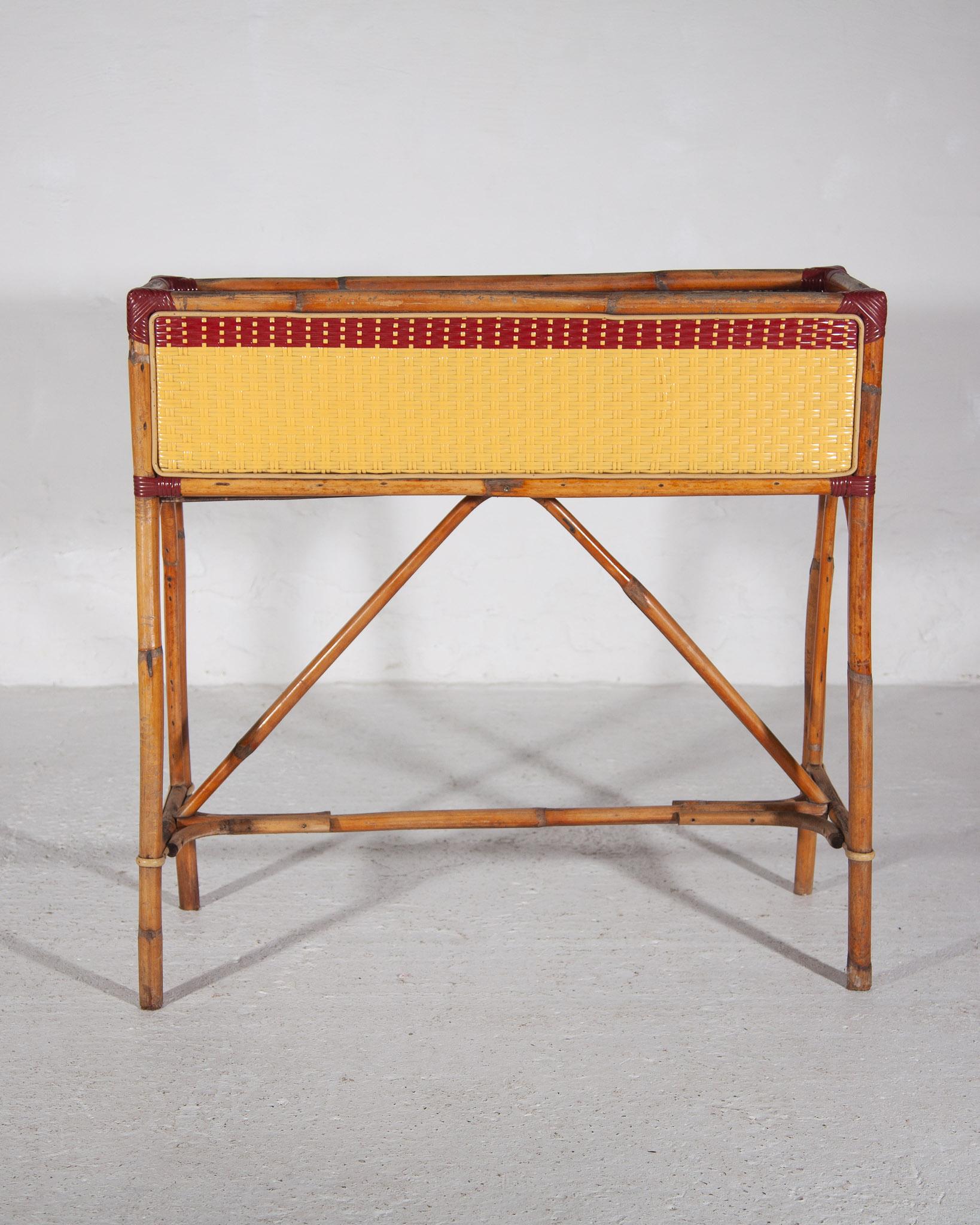 Set of  twoFrench bamboo rattan planters by Maison Gatti, 1950s made from one piece of hand-shaped bamboo frame and a rectangular planter with decorative geometric woven resin red and yellow stripes. Handcrafted made by Parisian artisans since 1920.