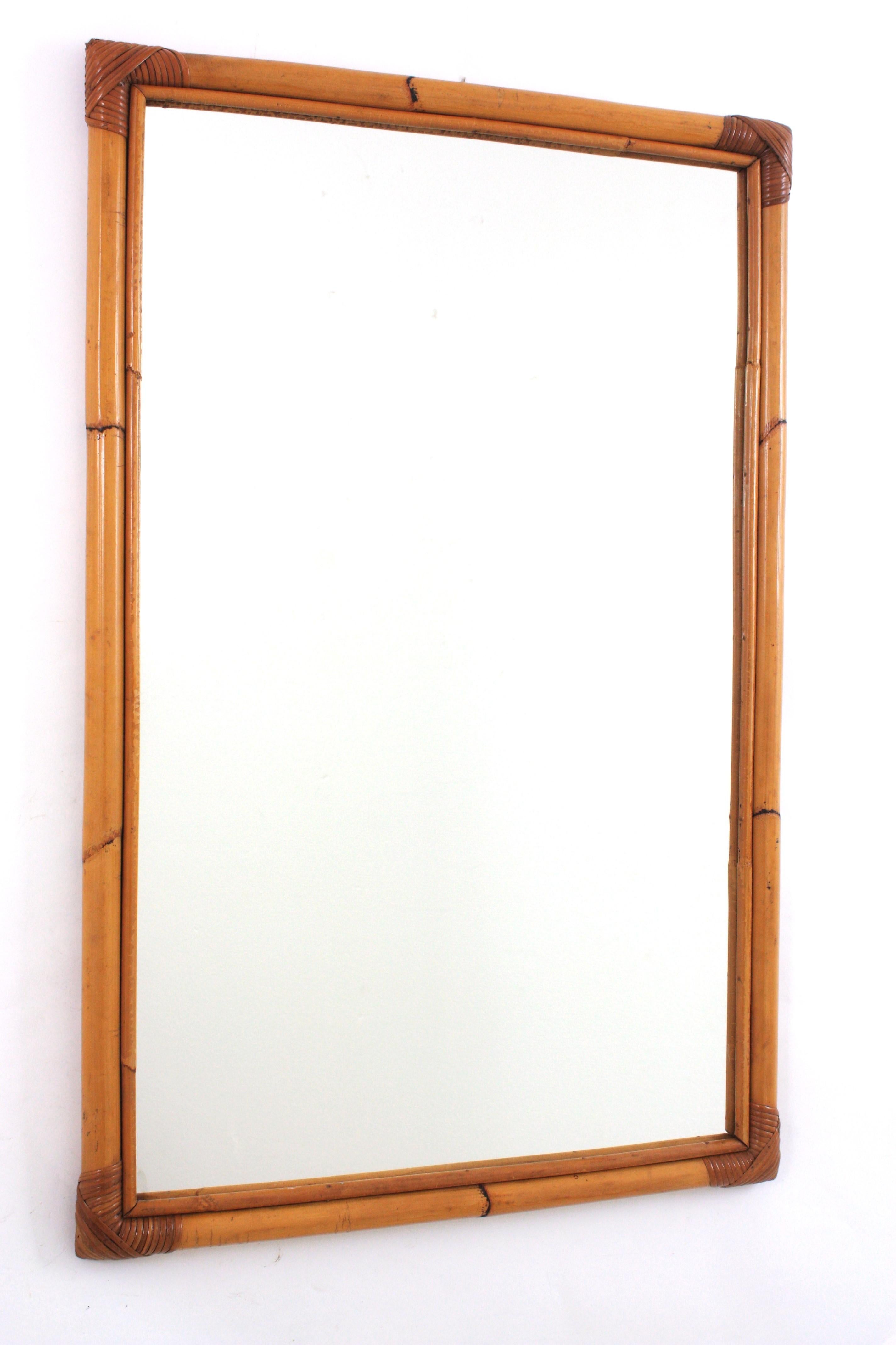 Rectangular large mirror, bamboo, rattan
Eye-catching rectangular mirror handcrafted with bamboo cane. Spain, 1960s.
Rectangular frame made of bamboo with wicker accents on the corners.
This mirror is in excellent vintage condition. Its large