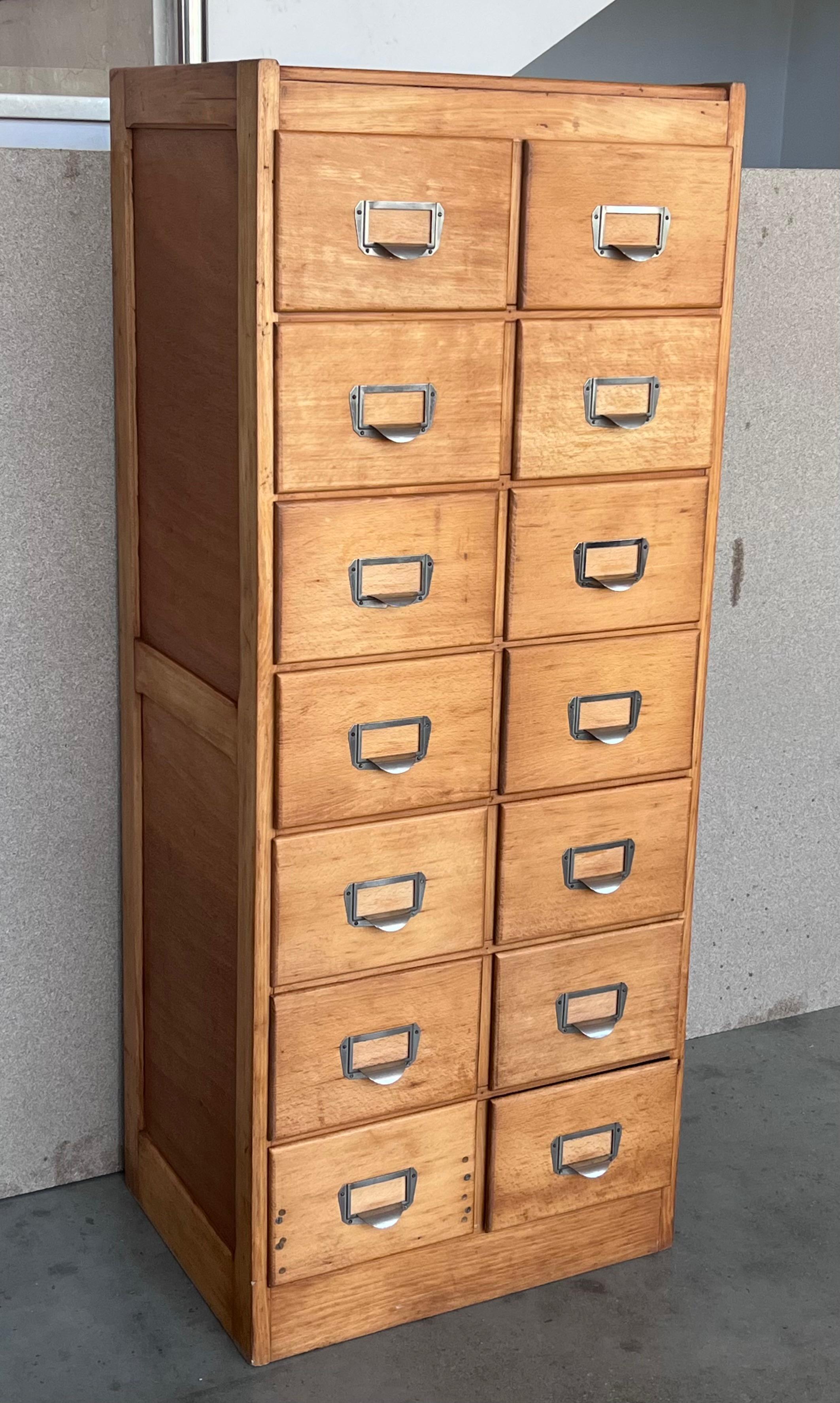 Large bank of French Art Deco filing drawers, circa 1930s. - solid oak drawers and frame - oak ply panels on the sides - geometric cup handles.