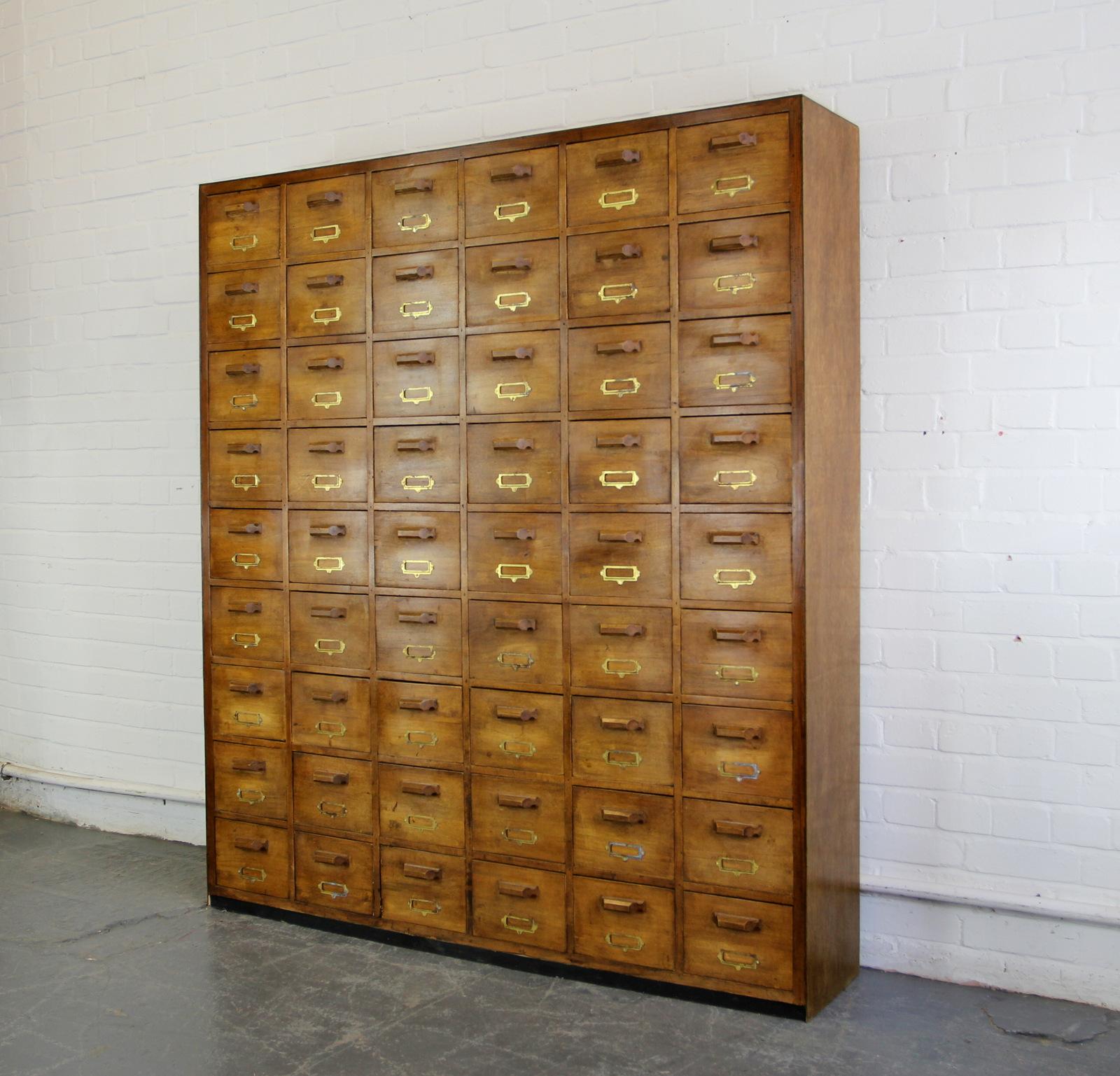 Large Bank Of French Haberdashery drawers, circa 1940s.

- Solid pine drawers
- Geometric Pine handles
- Brass card holders
- 54 identical drawers
- French, circa 1940s
- Measures: 152cm wide x 173cm tall x 31cm deep.
- Each drawer measures