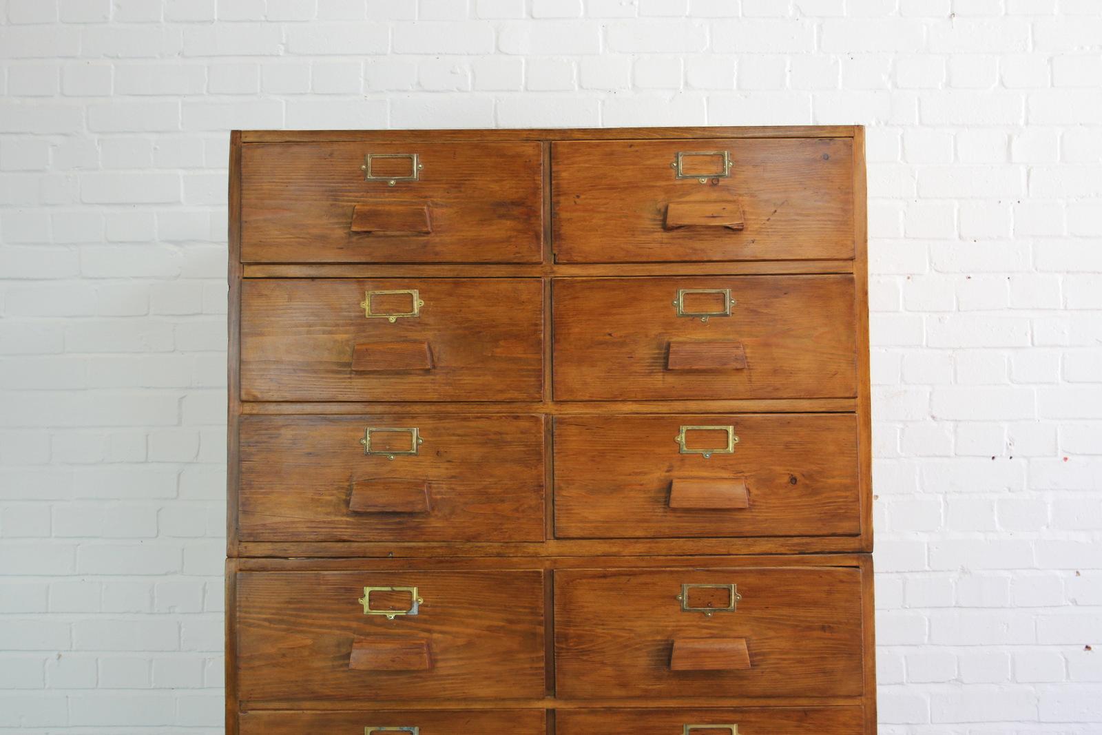 Large bank of pine Haberdashery drawers, circa 1950s.

- In two parts
- Shaped pine handles
- Brass card holders
- Pine sides and top
- 14 identical large drawers
- Dutch, circa 1950s.
- Measures: 103cm wide x 71cm deep x 168cm tall.
- Each