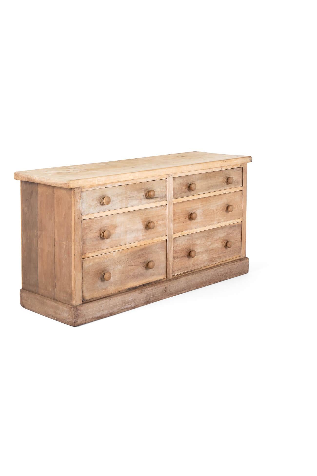 A large Victorian pine cabinet made of up of six deep  smooth running drawers.

Each drawer has two large original wooden knobs perfect for maximum storage solutions.

The top is made of a large thick oak slab top beautifully and naturally weathered