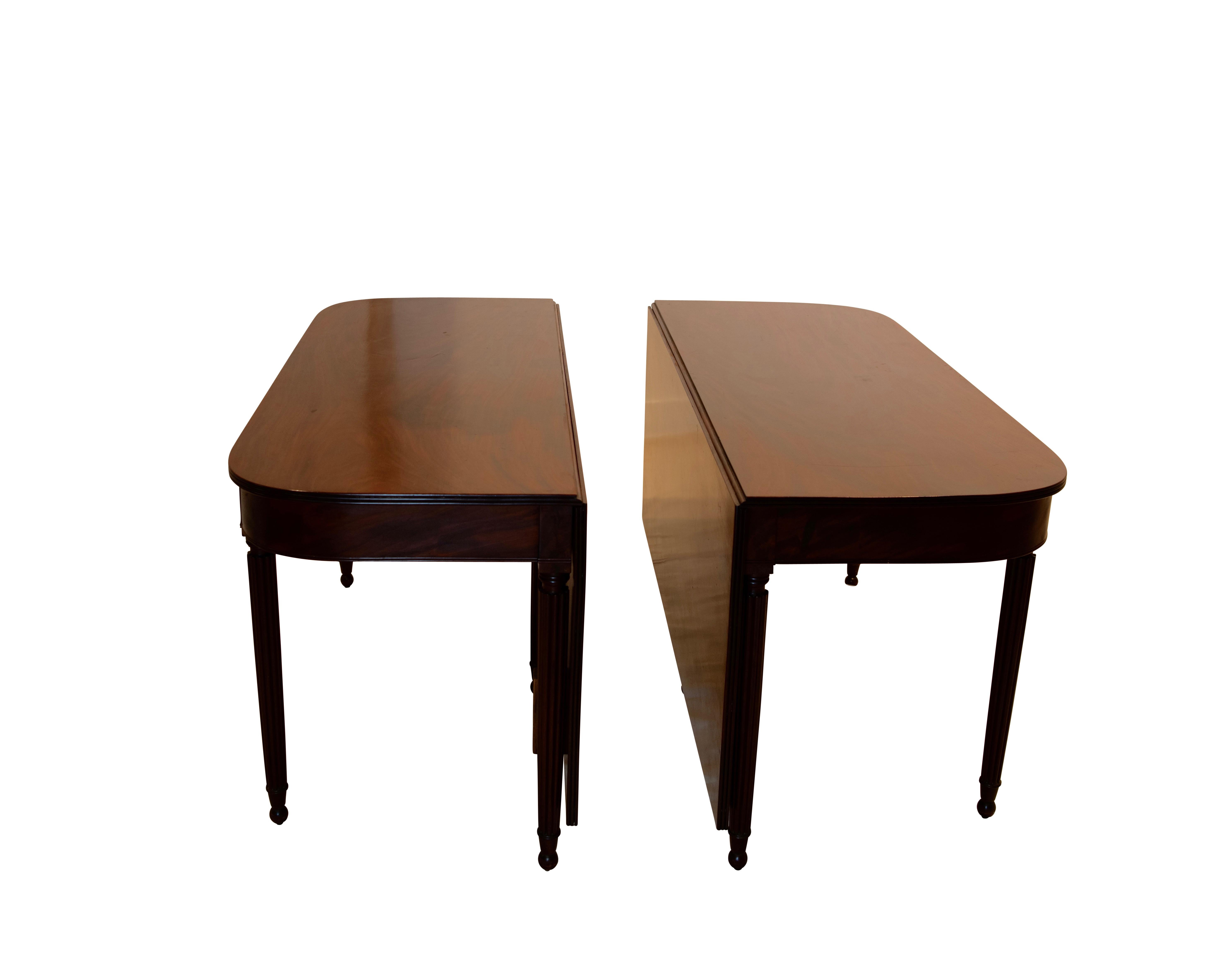 An unusually wide banquet size mahogany double gate leg D-end dining table with drop leaves, having reeded legs ending in ball feet. Table can easily sit twelve people. Most likely American, early 19th century.
Difficult for us to photograph