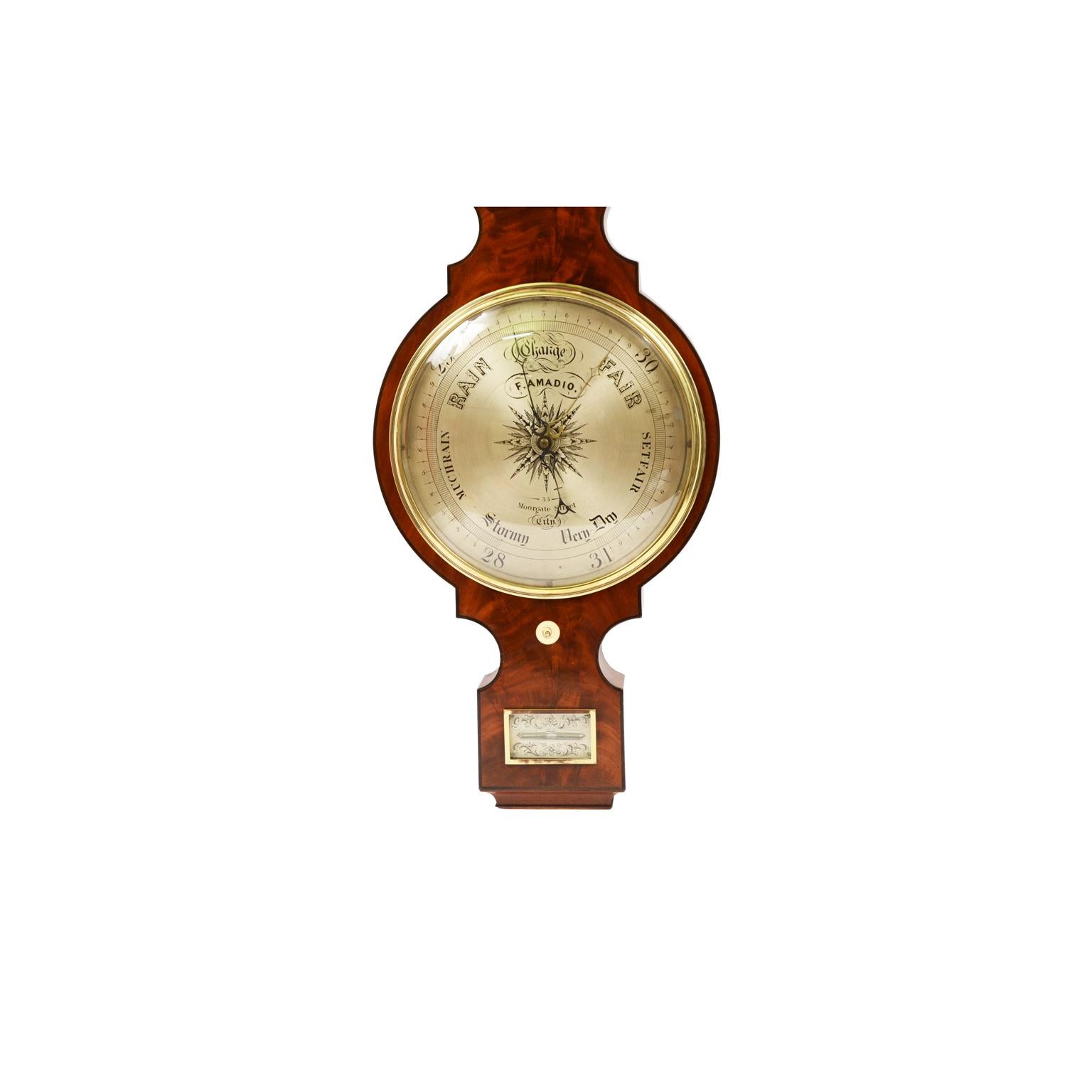 Rare large barometer complete with clock signed F. Amadio 35 Moorgate Street London active at this address between 1842 and 1851. Case of mahogany wood and finely worked mahogany root. Large silver-plated brass dial engraved with meteorological