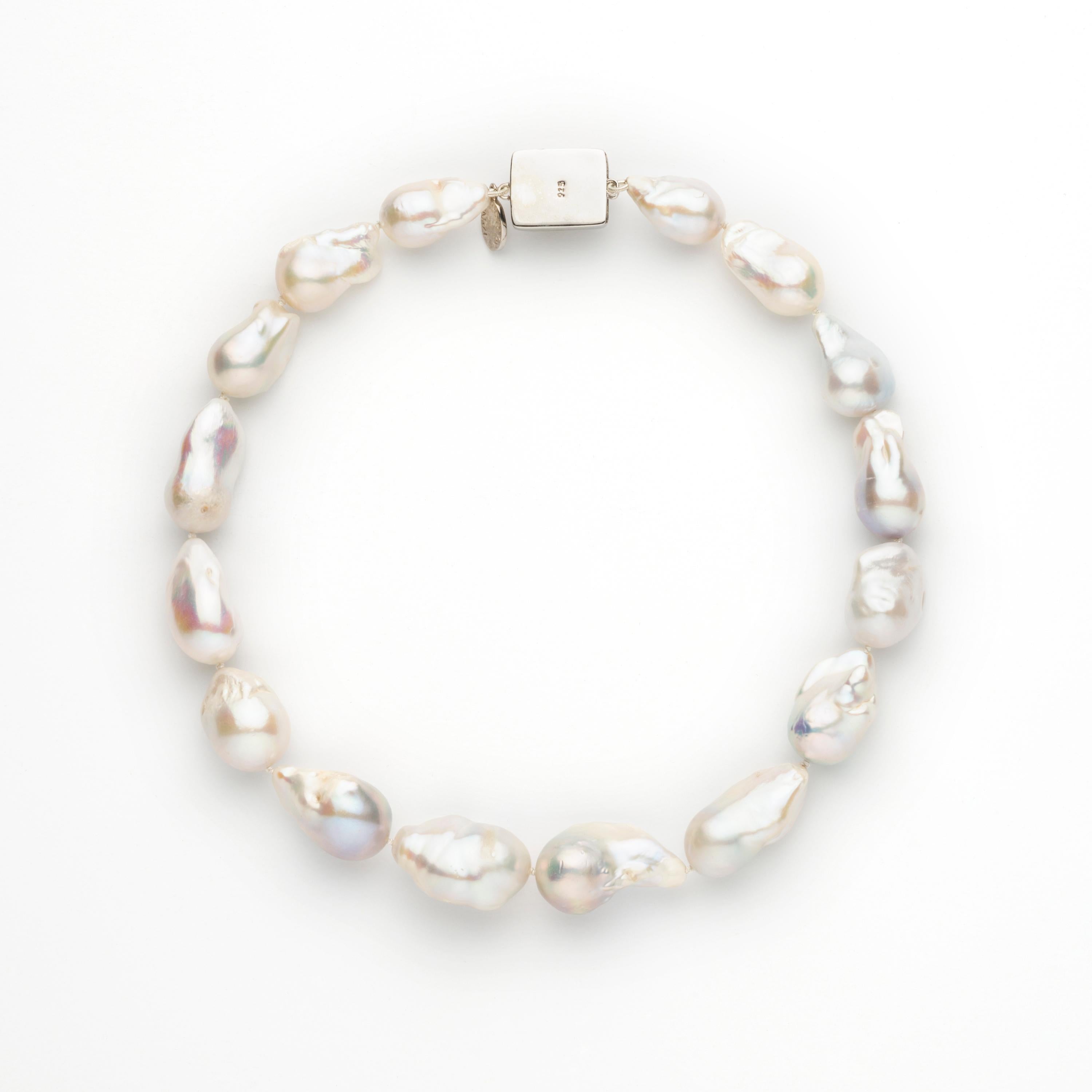 Jane Magon Collections, Soft Lustrous White Freshwater Pearl Necklace is approximately 14mm with slight graduation down. Individually knotted to the Rhodium Plated(so it won't tarnish and gives the look of platinum or white gold) Sterling Silver