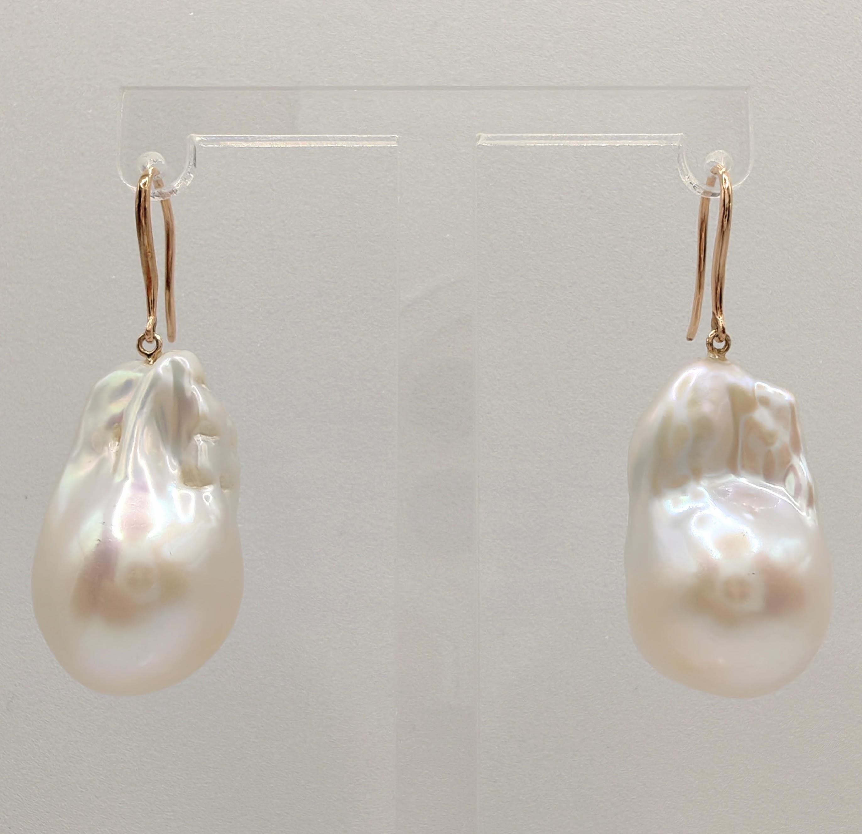 Indulge in the alluring grace of our Freshwater Baroque Pearl Dangling Drop Earrings, crafted to captivate and inspire. These remarkable earrings feature stunning Freshwater Cultured Baroque Pearls, boasting a brilliant white hue with a delicate