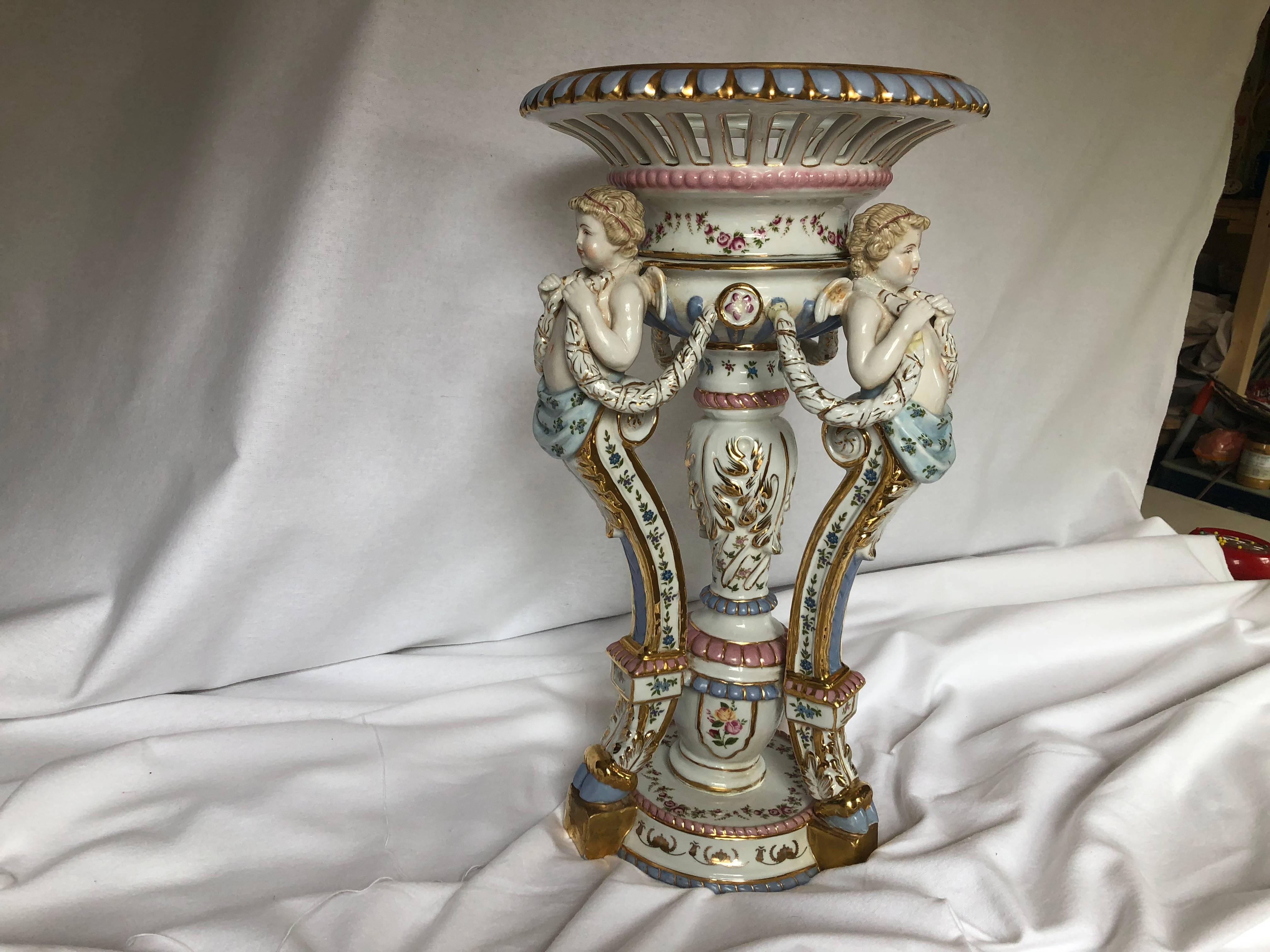 Absolutely exquisite large hand-painted porcelain centrepiece. This beautiful Baroque style centrepiece will create an impressive elegant atmosphere on any tabletop. Most likely made in the 1920s it shows some barely noticeable repairs and signs