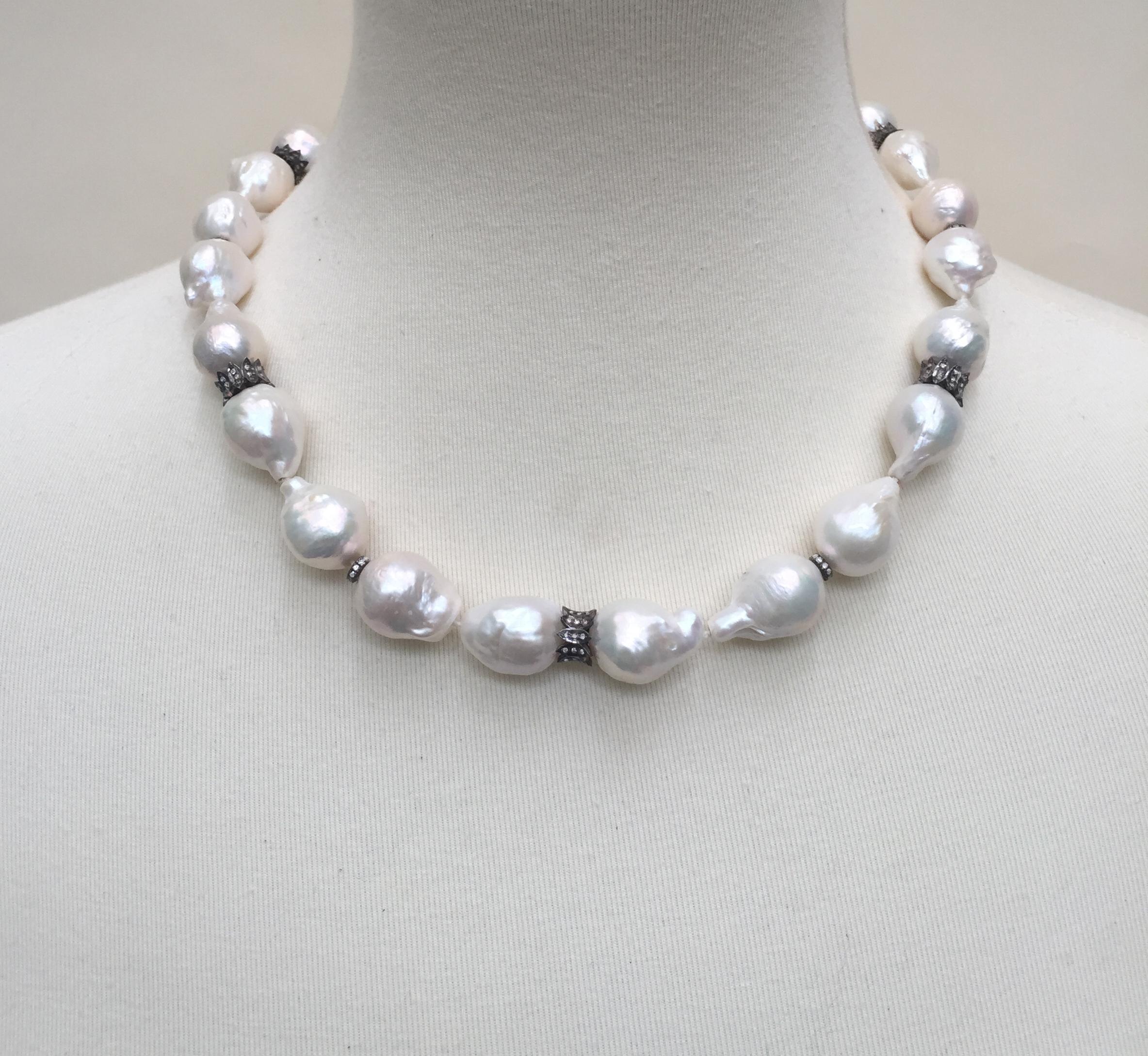 This striking necklace is made with large baroque white pearls with diamond and oxidite silver dividers and clasp. Marina J. composed the necklace with irregularly shaped pearls (8-16 mm) that come together in harmony with beautiful silver and