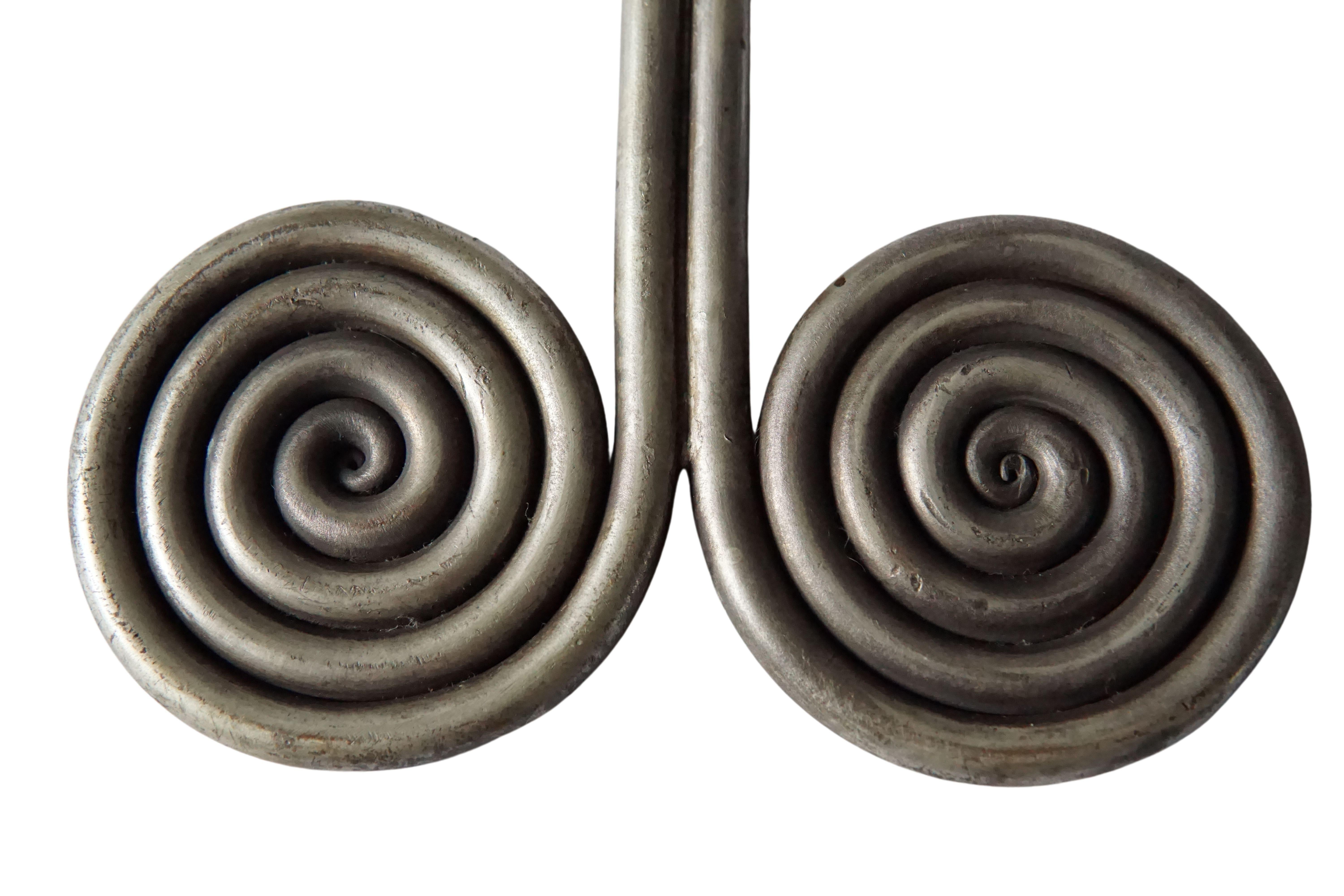 These large spiral brass earrings, crafted from a single thick brass wire are called 'Padung', a type of earring worn by the Batak Karo Tribe from northern Sumatra, Indonesia. This large low grade silver & brass spiral earring are completely solid,