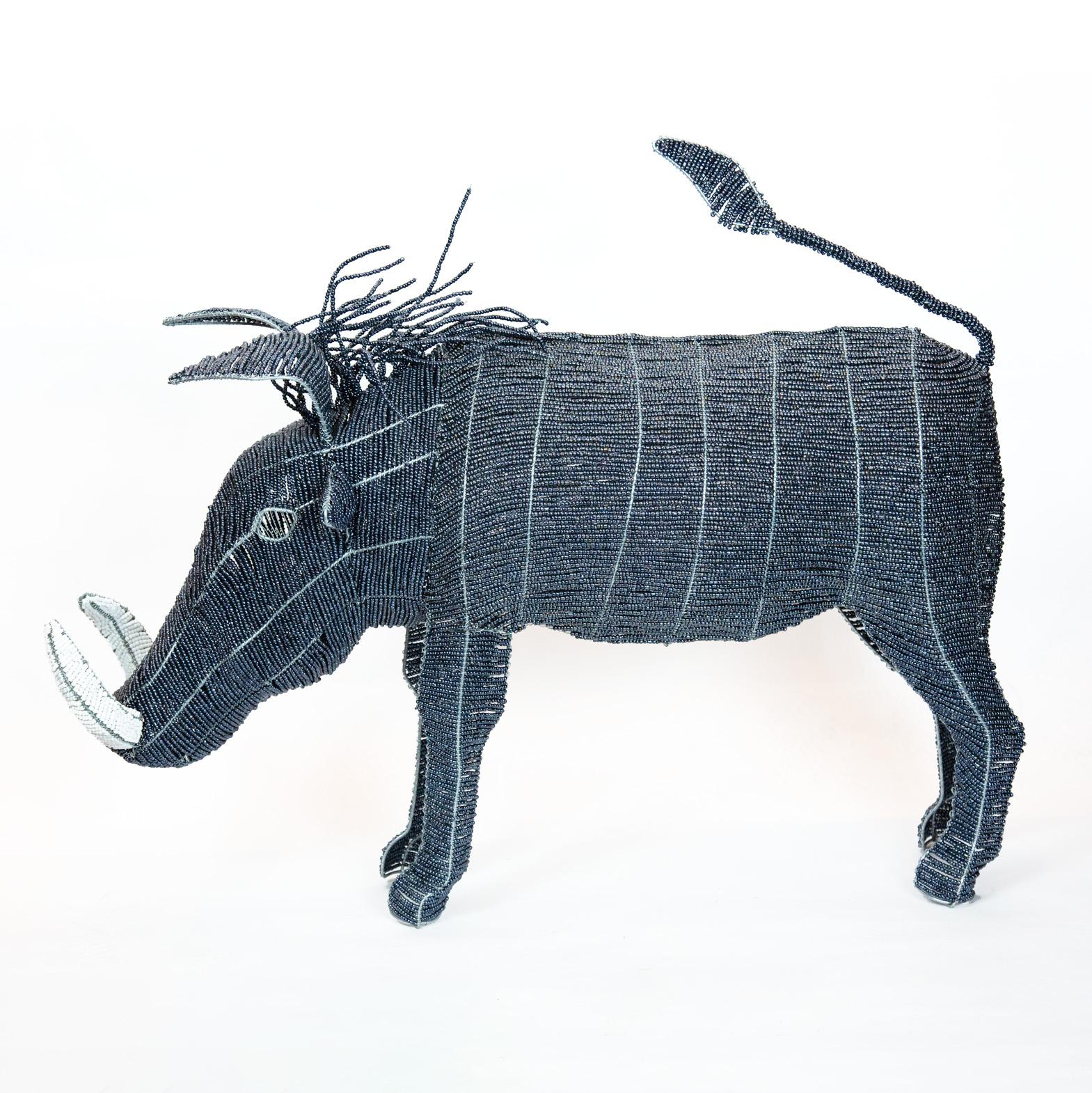 Large Beaded African Warthog.  Handmade in Africa from beads and wire.  Deep-blue metallic body, hair, and tail with white tusks.

36