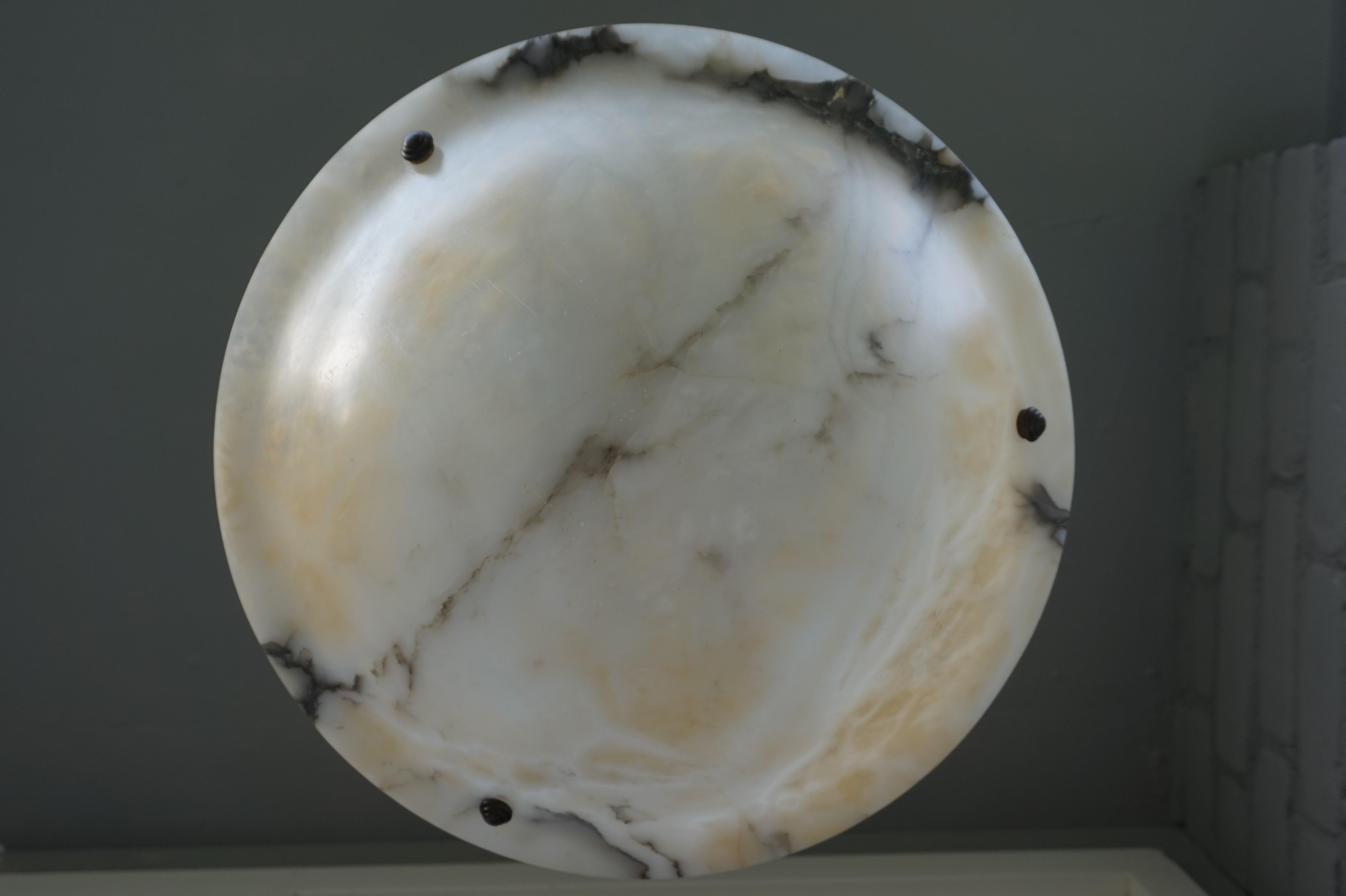 Large and timeless design mineral stone pendant.

This alabaster pendant could be the cherry on the proverbial pie when it comes to creating just the right atmosphere in your entrance, kitchen or bedroom. This fine example breathes calmness and its