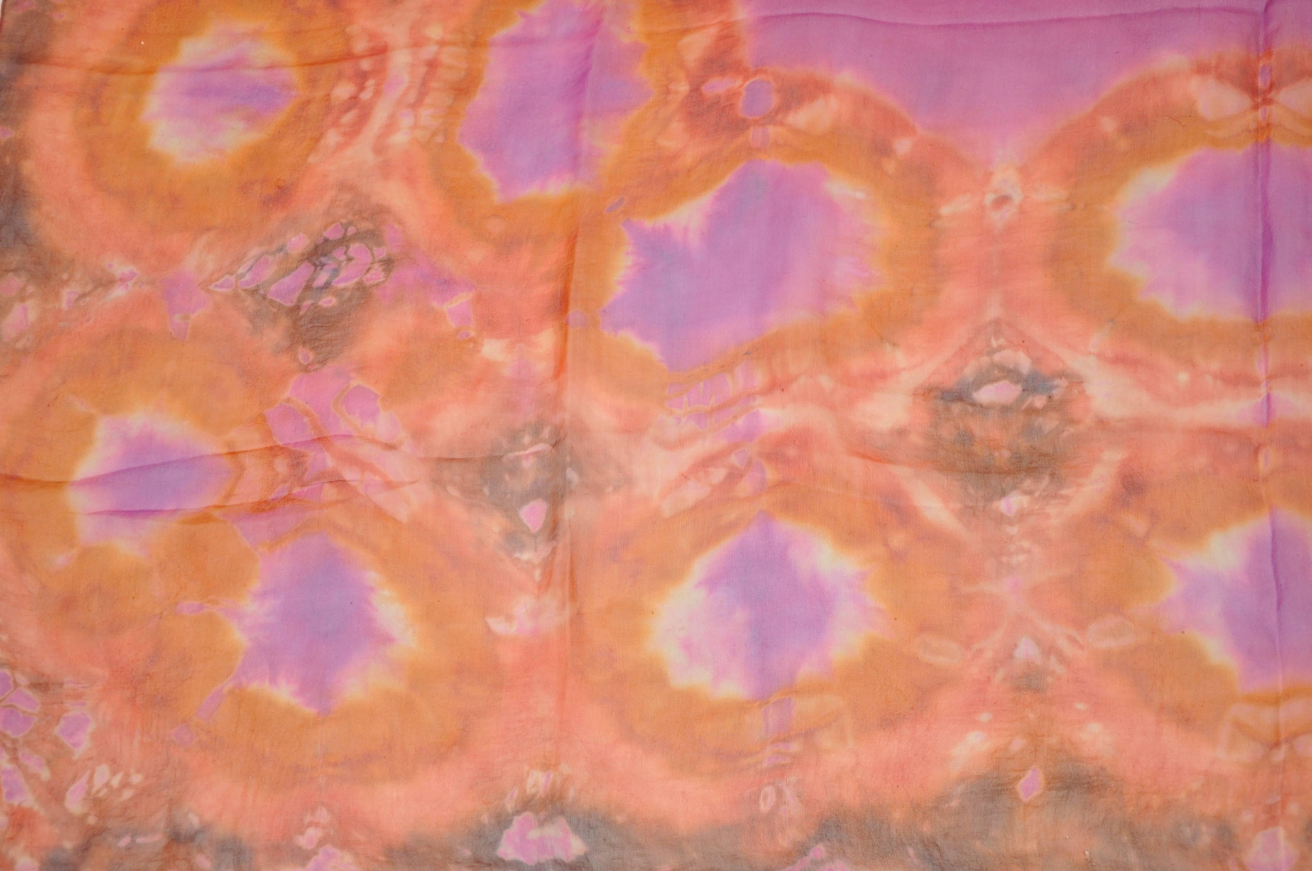      Large Beautifully detailed with multi-colors of fuchsia & tangerine hand-tie-dyed silk chiffon scarf is accented with hand-rolled edges and measures 50 1/2 inches by 52 inches. Made in Italy.