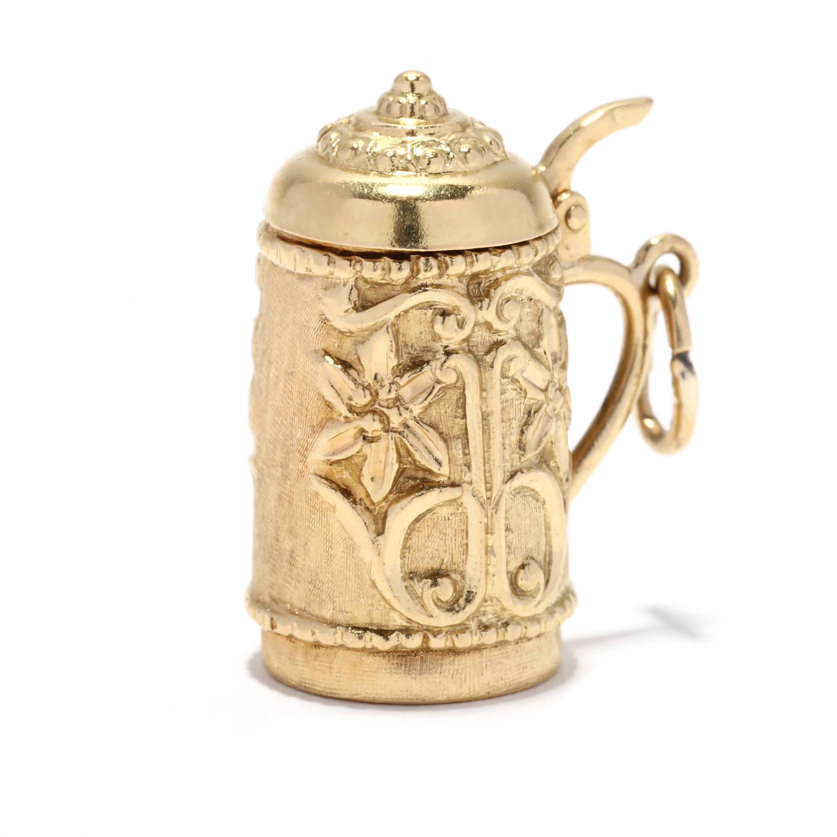 A vintage 18 karat yellow gold large beer stein charm. This oversize charm features a beer mug design with a scroll and floral motif, and with an articulated top that opens and closes.

Length: 1 in.

Width: 1 in.

Weight: 4.1 dwts.



Ring Sizings