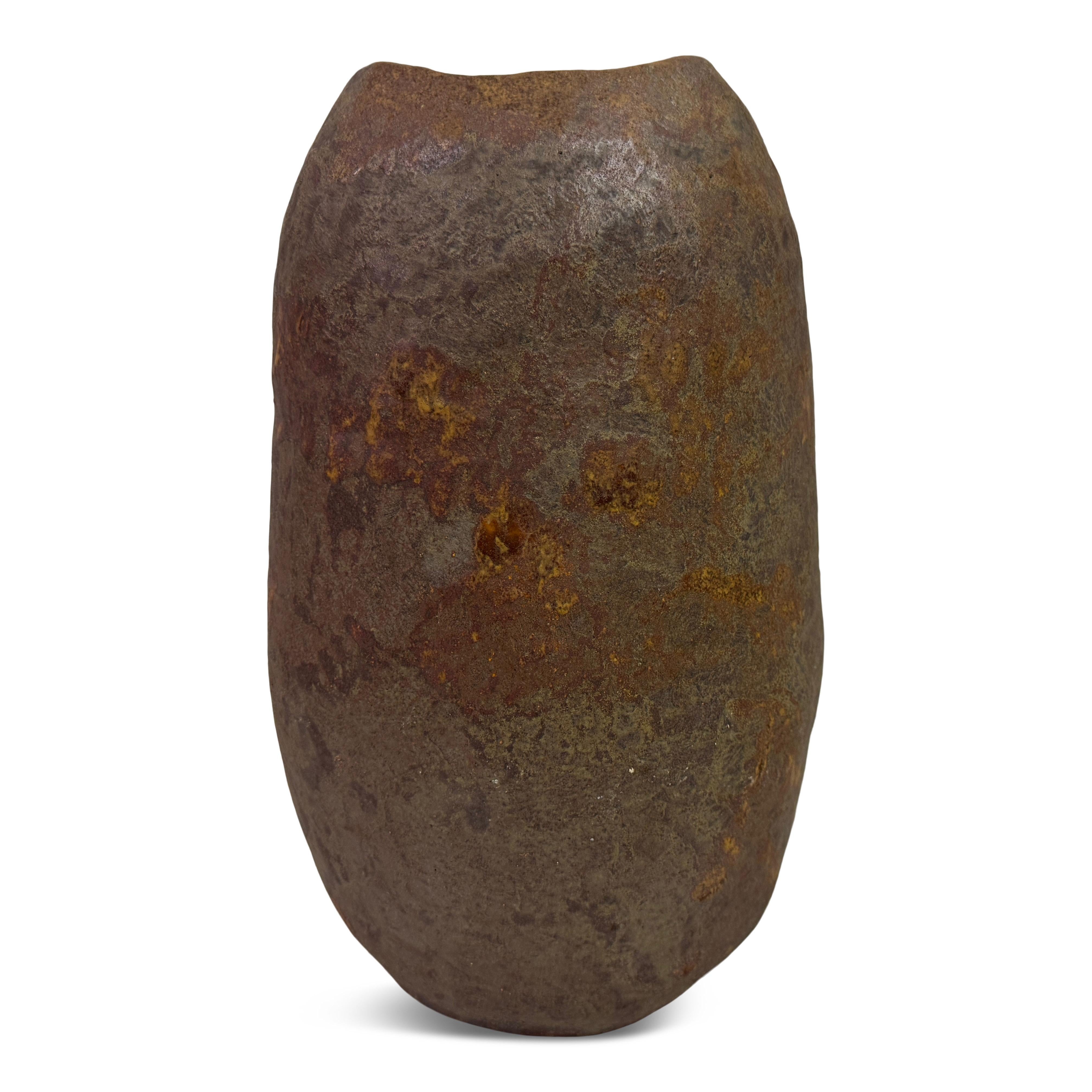 Belgian brutalist stoneware vase

A strikingly sculptural brutalist stoneware vase with a heavy, monolithic presence. Its organic, asymmetrical form is hand-built and subtly faceted, offering a raw, primal aesthetic. The surface bears a coarse,
