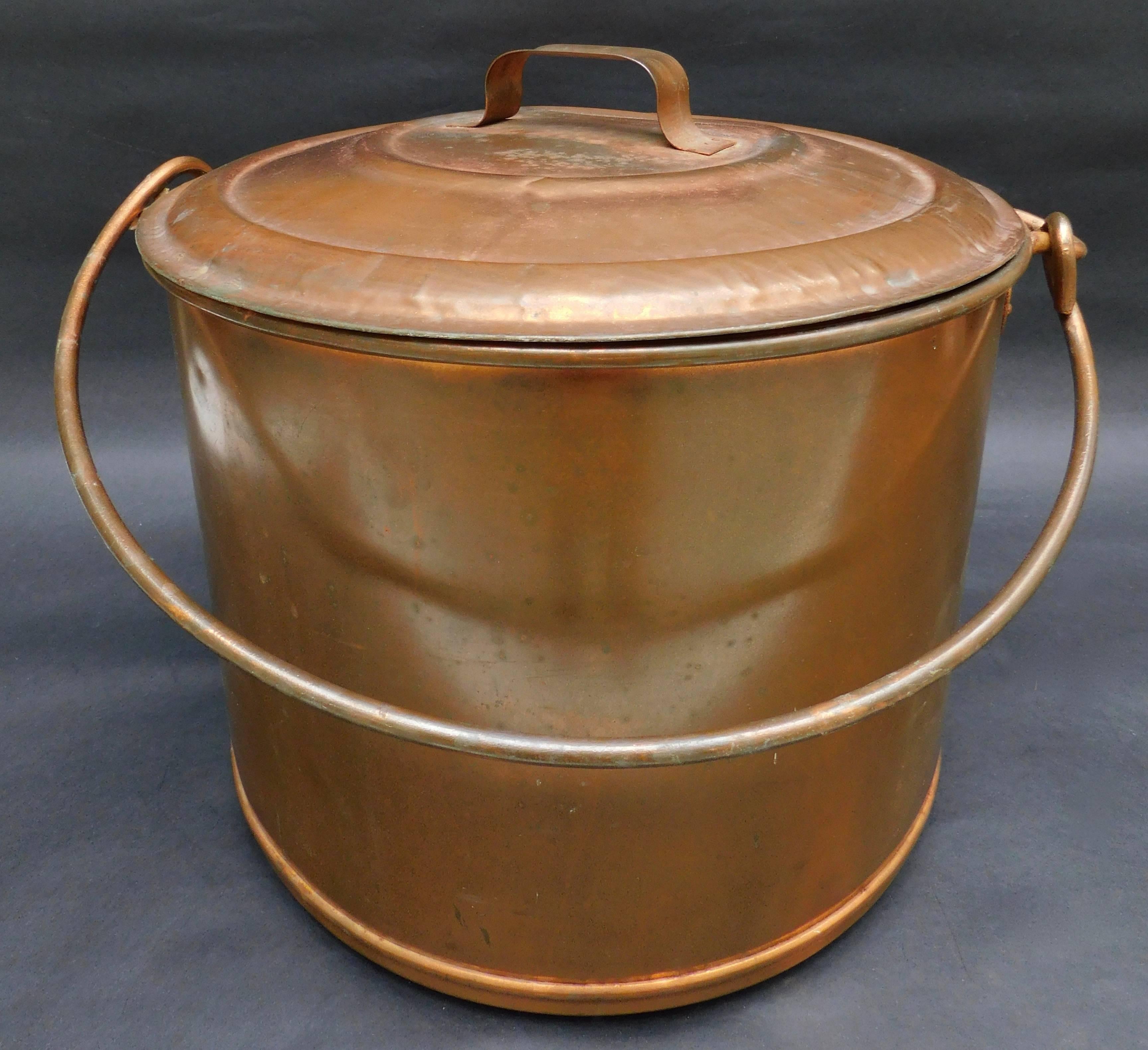 Dating to the 1940s, this covered pot would be great to use to store pet food or logs.... but you can also fill it with ice and chill wine and beer for your next party!
The measurements include the handle on top and loops on the sides.