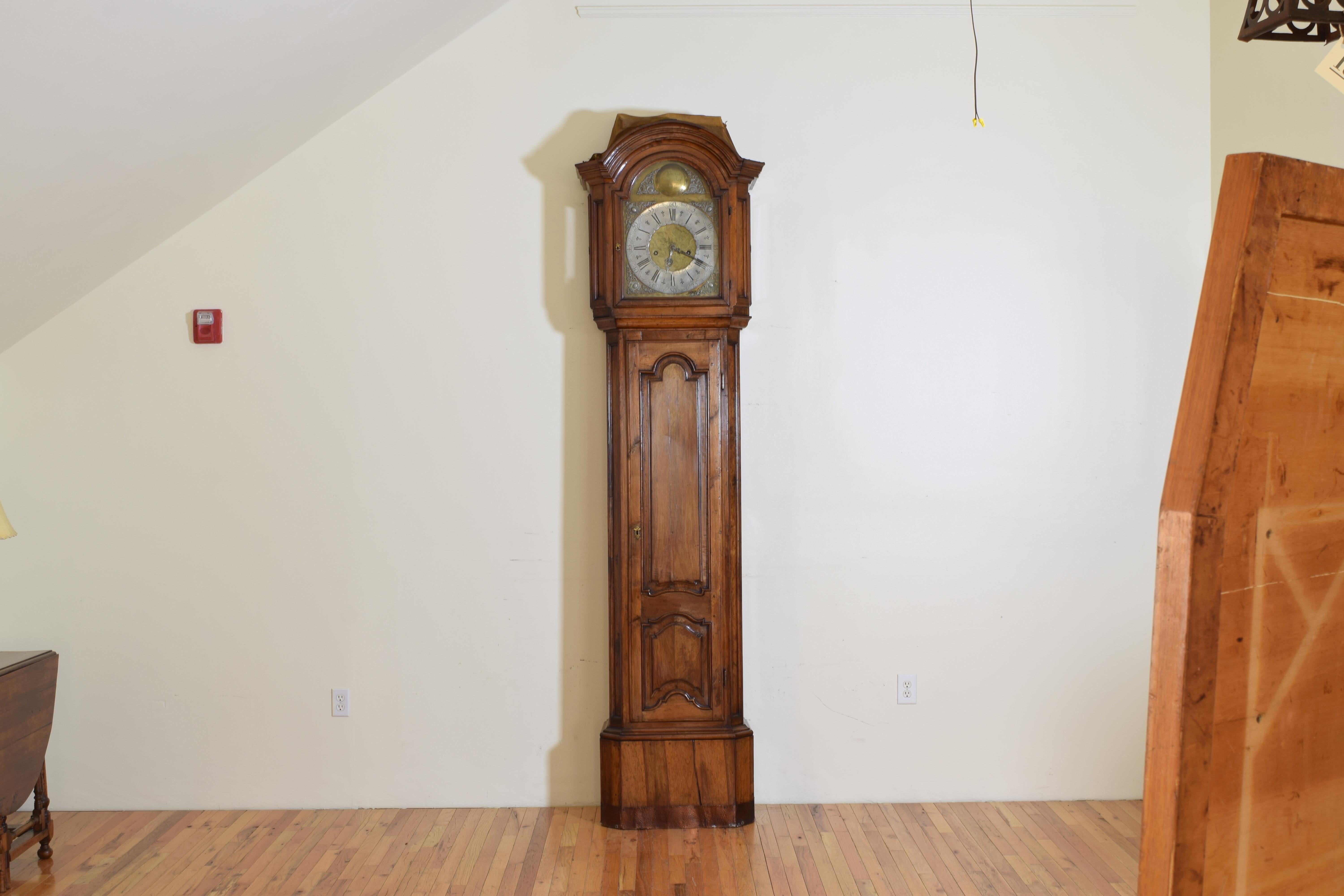 Appearing to have the original clockworks made by Nicolas De Beefe A Malines, recently serviced, this massive case is constructed entirely of walnut and represents a transition in styles of the second quarter of the mid-18th century, the works has a
