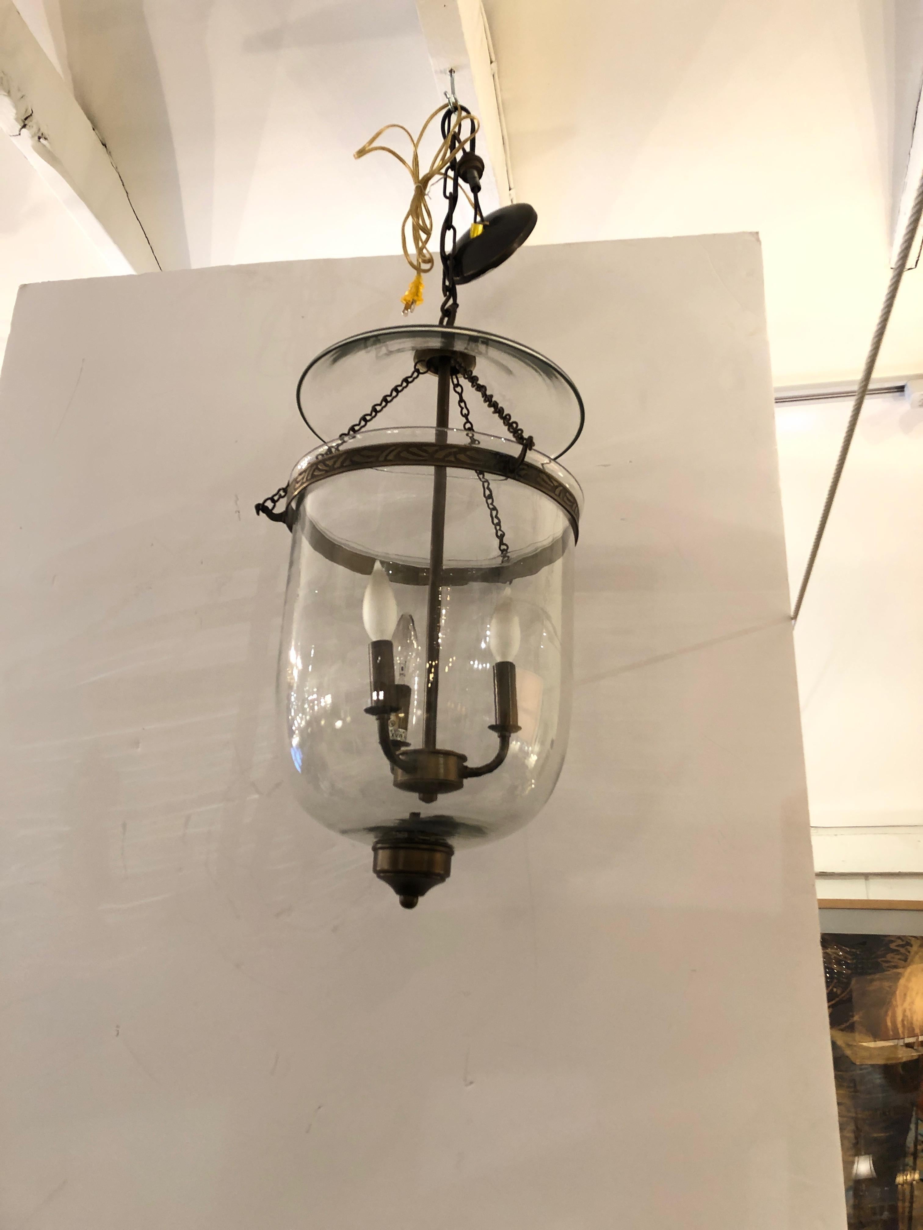 A beautiful and unusually large bell glass lantern having rich bronze finish brass and original ceiling cap. 3 arms, 25 watt each

Note: Pair available for $2900.
