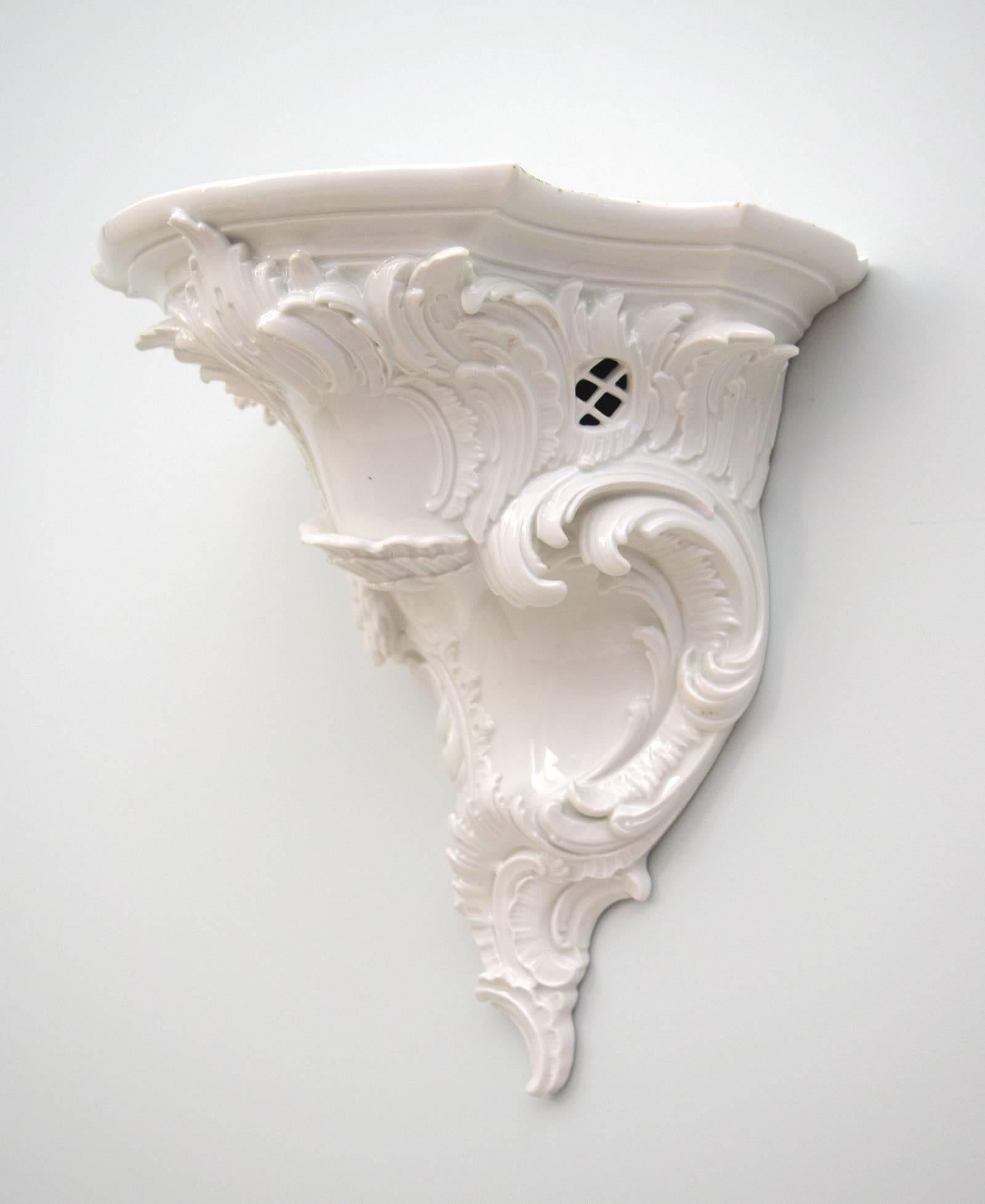 This charming yet substantial Neo-Rococo bracket was made in Berlin by KPM, the royal porcelain manufactory. Finely modeled, and pierced, the animated design is attributed to Alexander Kips, and dates to circa 1900.