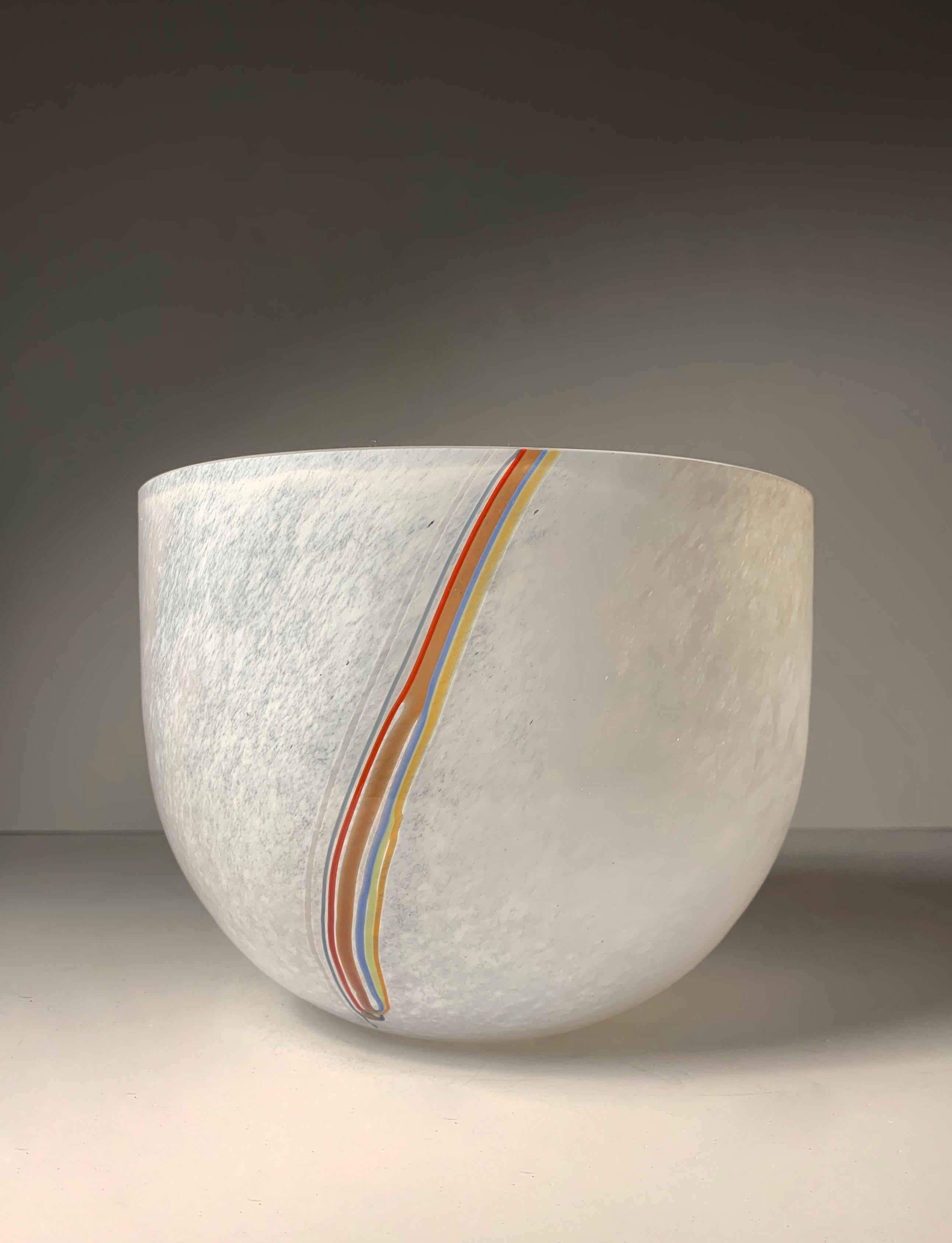 A large handcrafted decorative glass bowl with multicolored strands of glass to the sides, designed and made by Bertil Vallien for Kosta Boda. Etched to the bottom of the piece 