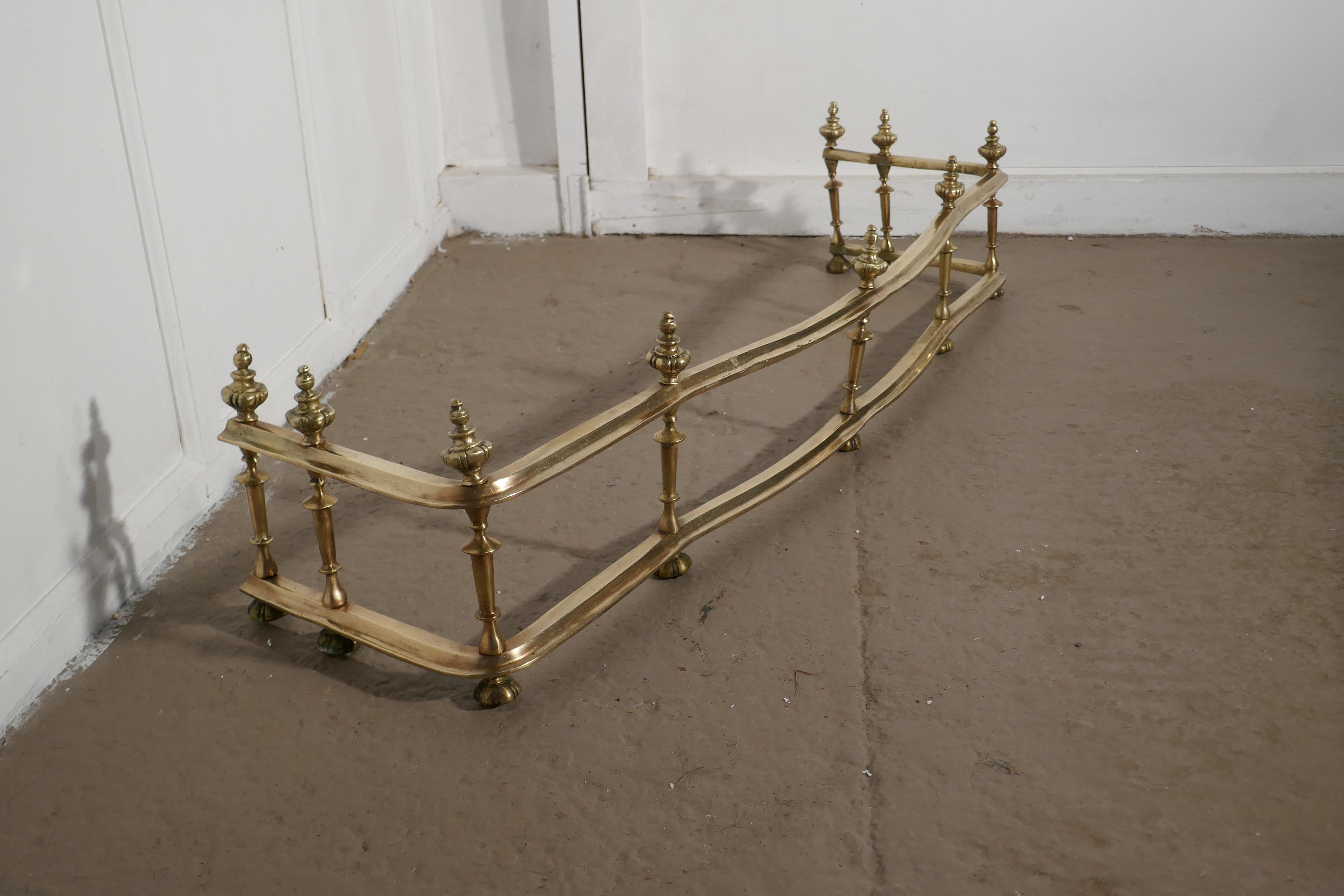 Large best quality 19th century heavy brass fender

This is a superb quality brass fender it has a deep with handmade spindles joining the 2 solid brass rails

The fender has an unusual waved shape
The fender is in good vintage condition it is