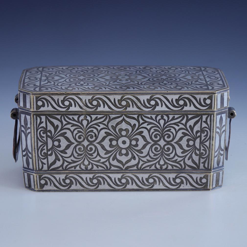 Large Betel Nut Box, Maranao, Southern Philippines (Mindanao).
Bronze with bordered silver inlay design overall of a symmetrical floral tendril vine pattern referred to as “the okir pattern”,  a traditional design for the Maranao people. This large