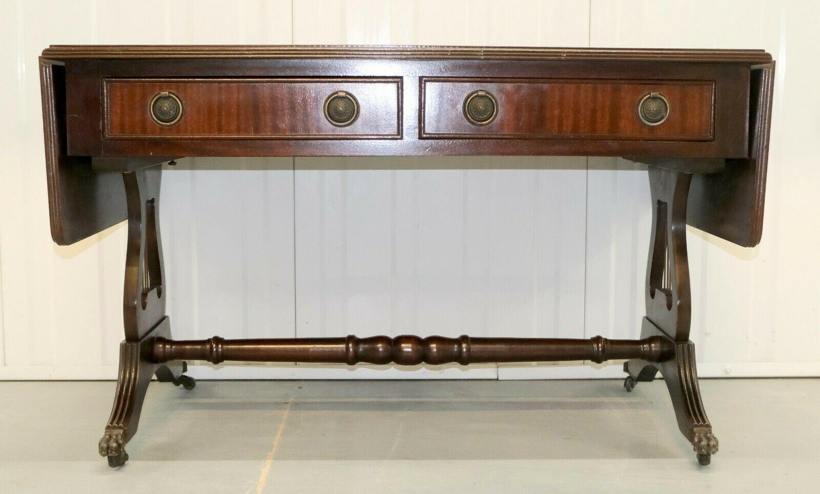 We are delighted to offer for sale this lovely vintage Bevan Funnell brown leather top drop leaf console hall/end side table.

The item is well presented with gilt tooled leather panels, fitted with two drawers, raised on lyre end support with