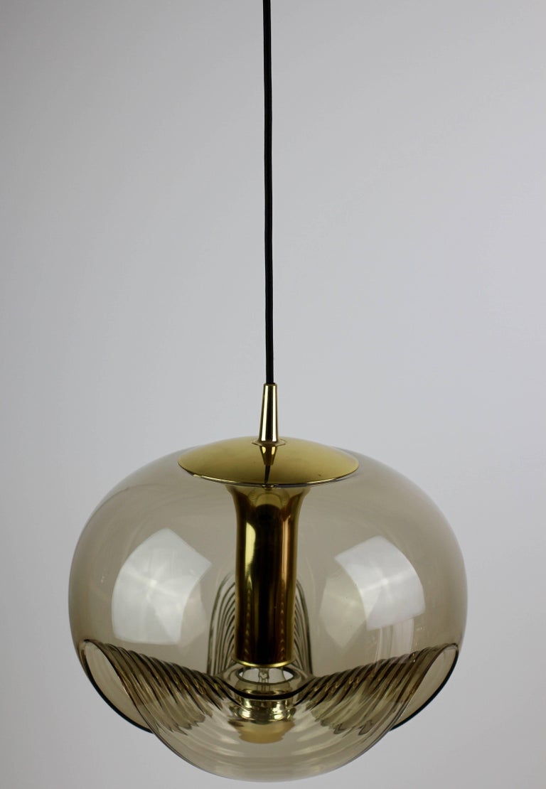 Beautiful midcentury design by Koch & Lowy for Peill & Putzler in the 1970s. This is an absolutely Classic piece of design, featuring a smoked colored (colored) glass globe shade with a waved/ribbed moulded bubble form, casting a beautiful rippled