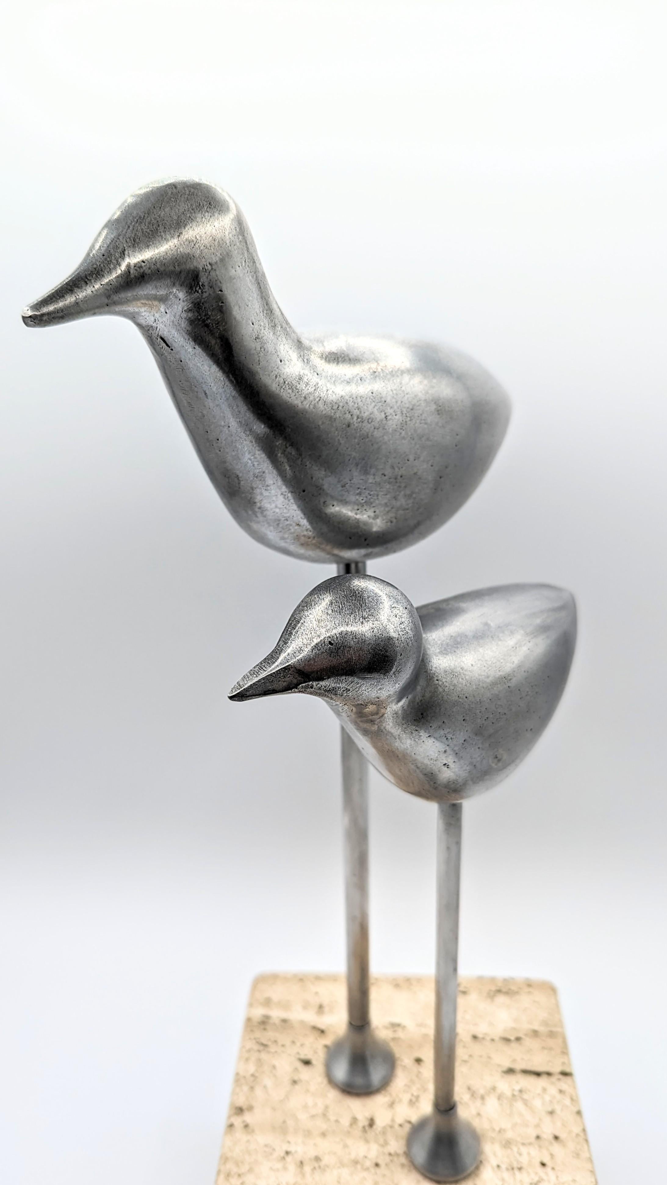 Rare and beautiful birds sculpture in aluminum on travertin and wood base, manufactured in France in 1970s. Very decorative object and very good manufacture.