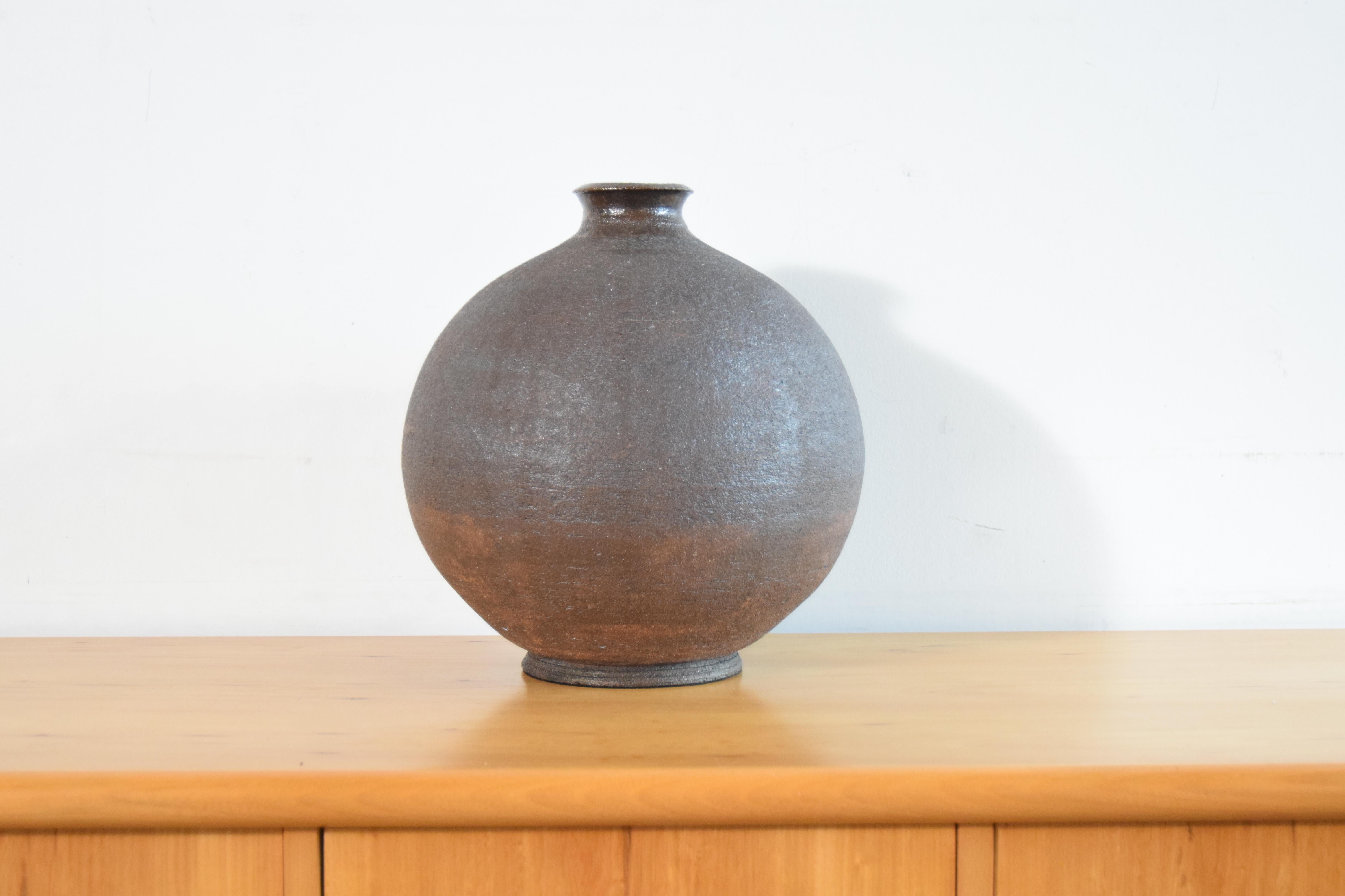 Large bulbous pottery vase, circa 1974, in the style of Bitossi. A very well executed object. Felted bottom. 


Measures 12 5/8