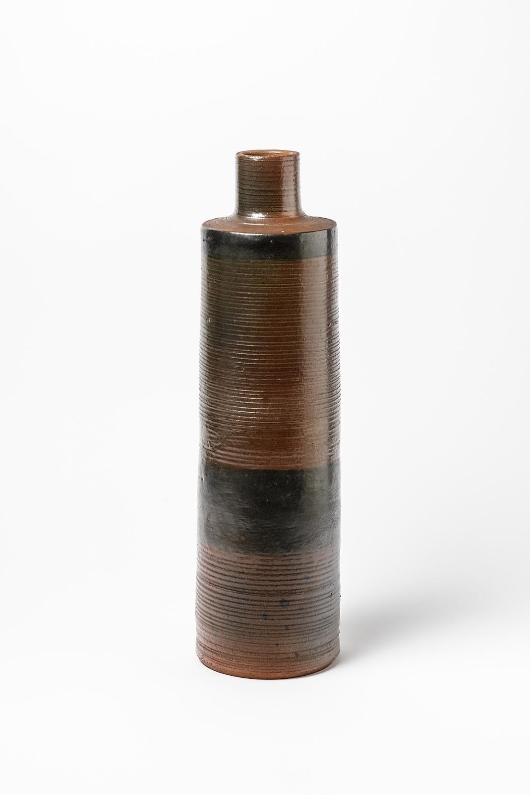 Nicole Giroud

Large and Elegant black and brown stoneware ceramic vase

XXth mid century design

Original perfect conditions

Signed under the base, circa 1970

Measures: Height: 47cm large: 13cm

Price is only for the big vase on the