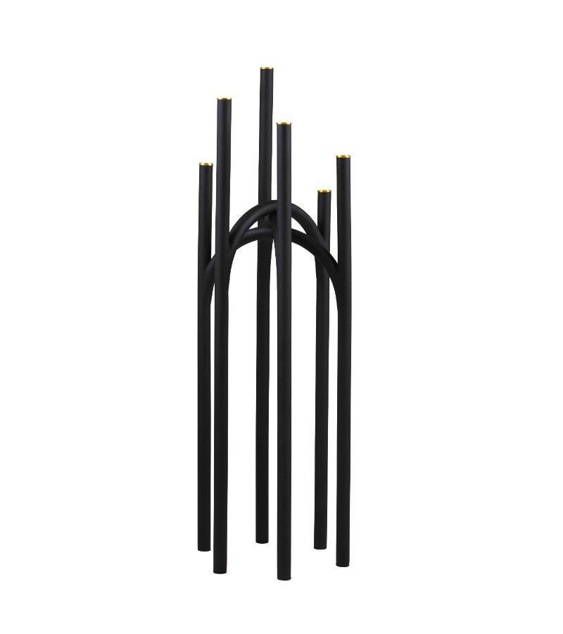 Large black and gold contemporary candleholder 
Dimensions: L 30 x W 26 x H 92 cm 
Materials: Iron. 
Also available in size small. 

The newest member of the family reinterprets classic traditions of candleholders. With its staggered and