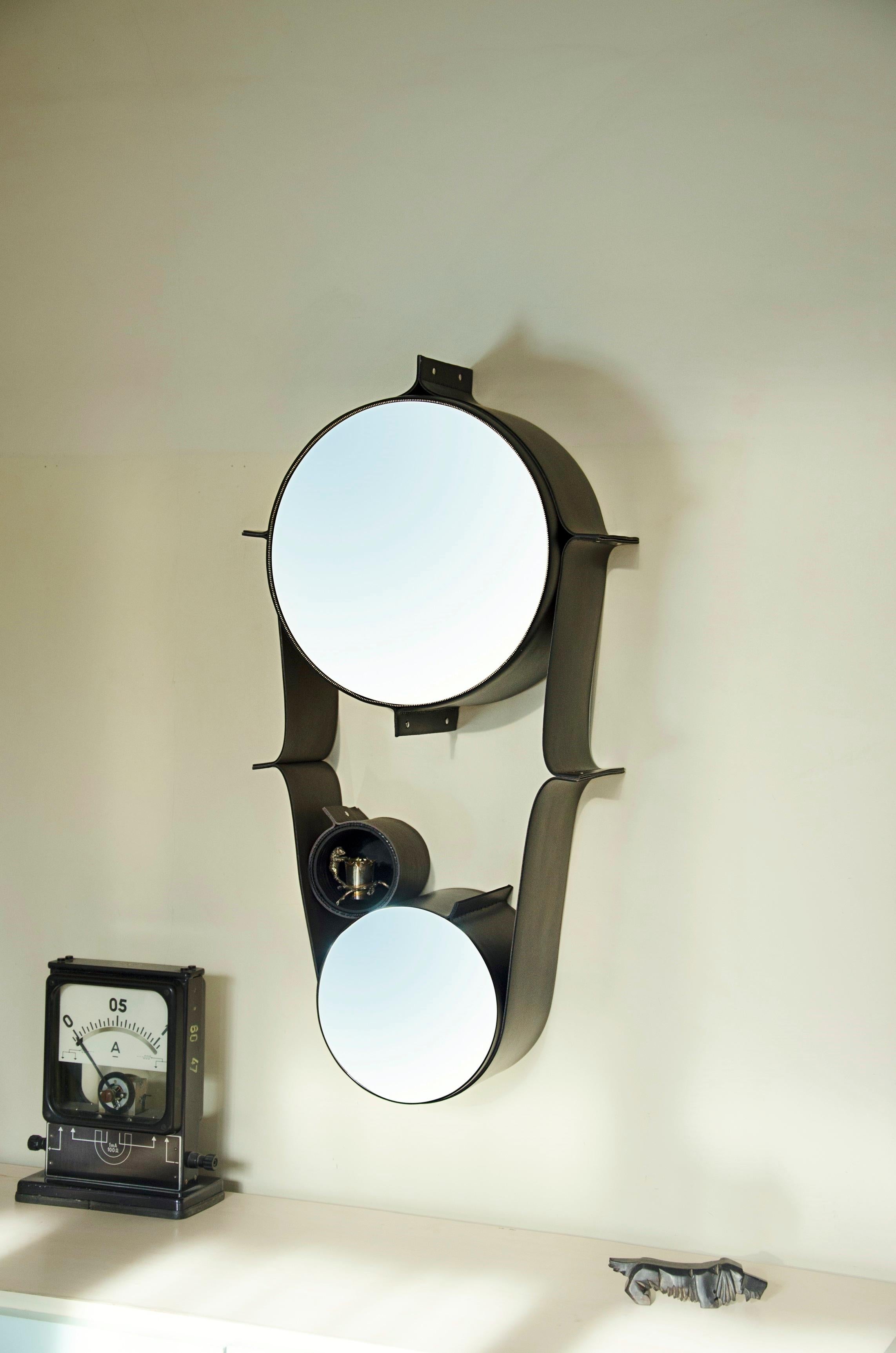 Large wall double mirror wrapped in leather
One large wall-mounted mirror (30cm/11.811 inches), surrounded by a leather staps on which two mobiles “box mirrors” (20cm/7.87 inches, 16cm/6.29 inches) are harmoniously laid at opposite ends of the