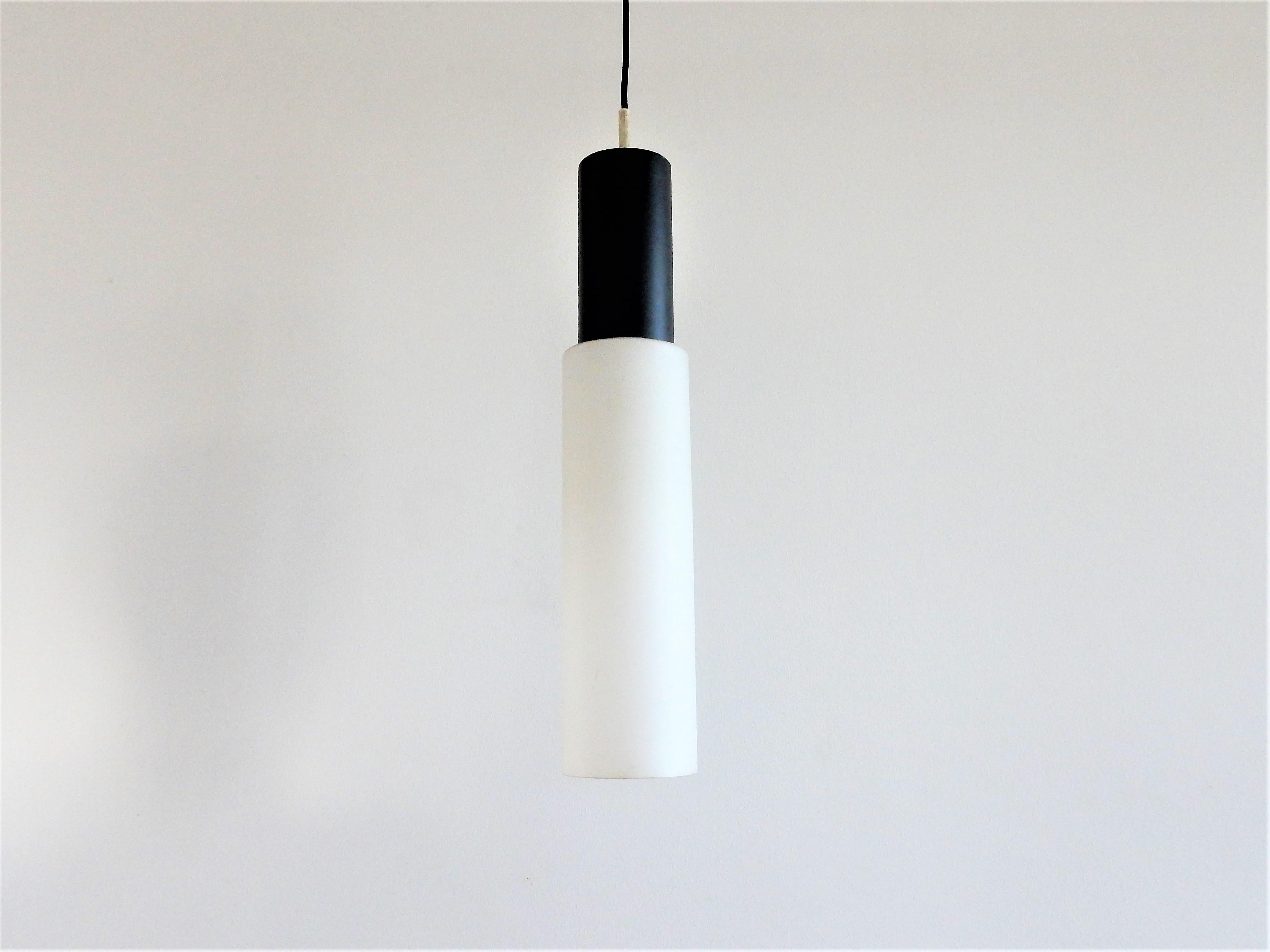 This stunning pendant lamp, model 238, is made by the Dutch company Evenblij in the 1960s. It is made of a frosted black metal top with a white opaline glass cylinder. These lamps are in a very good condition with some smaller signs of age and