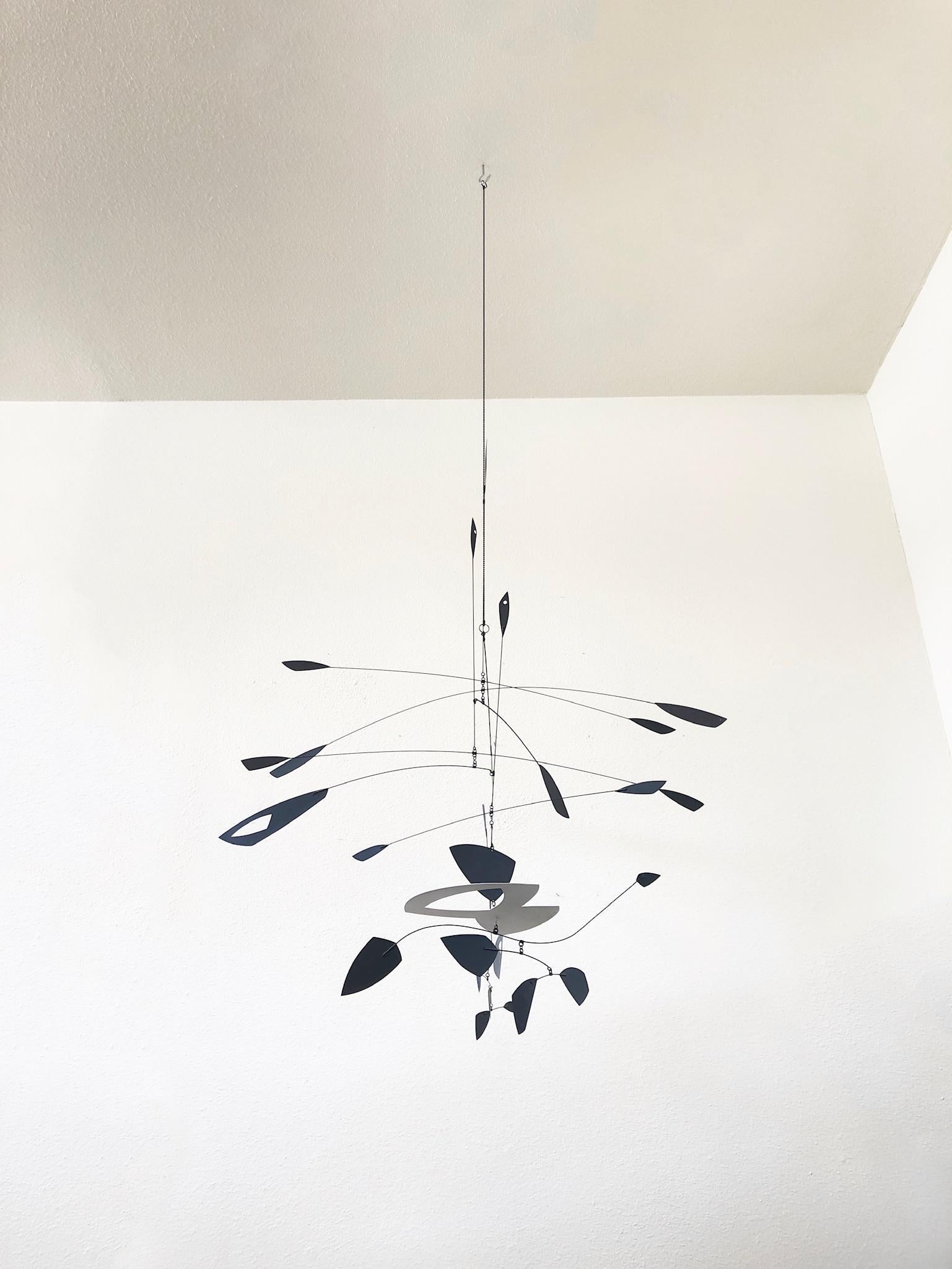 Large hanging black and white kinetic mobile sculpture by Colorado artist Robert Delaney.
This is one of his early pieces. Stamped R. Delaney 2000 on the white section. 
His work can be found at Kirkland Museum of Fine and Decorative Art in