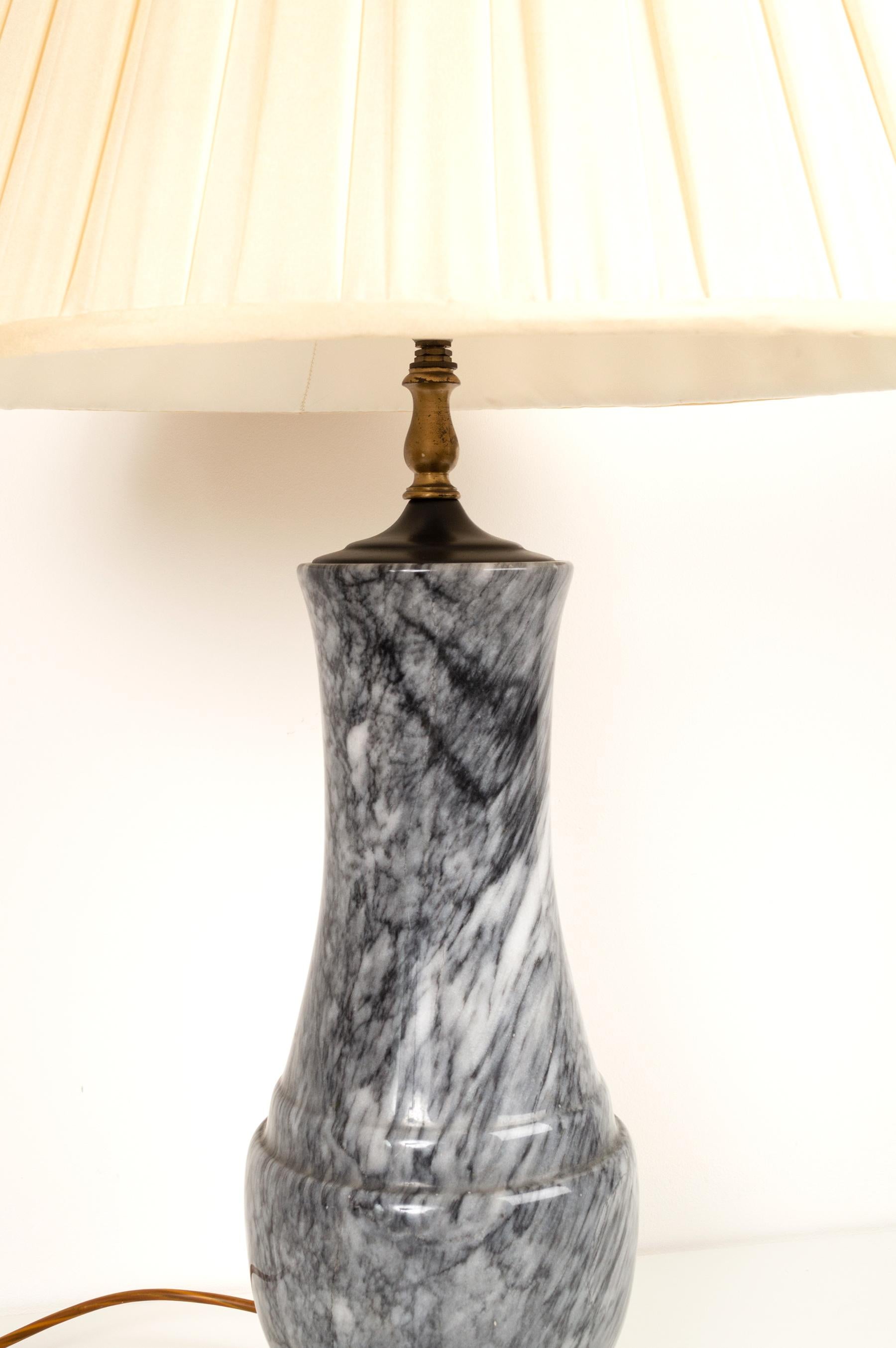 A classically shaped large table lamp, constructed from a single piece of solid marble.
Dating from C.1970.
Colour of marble: Black, white and grey

Presented in excellent condition commensurate of age.