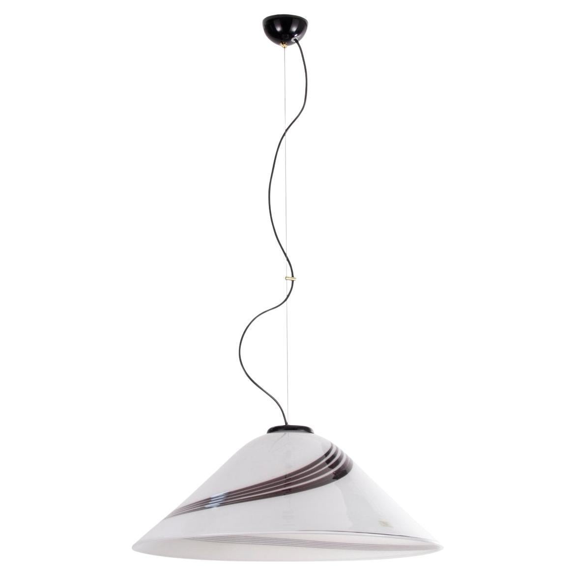 Beautiful vintage Murano glass pendant lamp made in Italy in the 70s/80s. The large size of the blown glass (about 65 cm in diameter!) the elegant shape and the refined glass workmanship with black spiral filigree make the lamp a unique and valuable