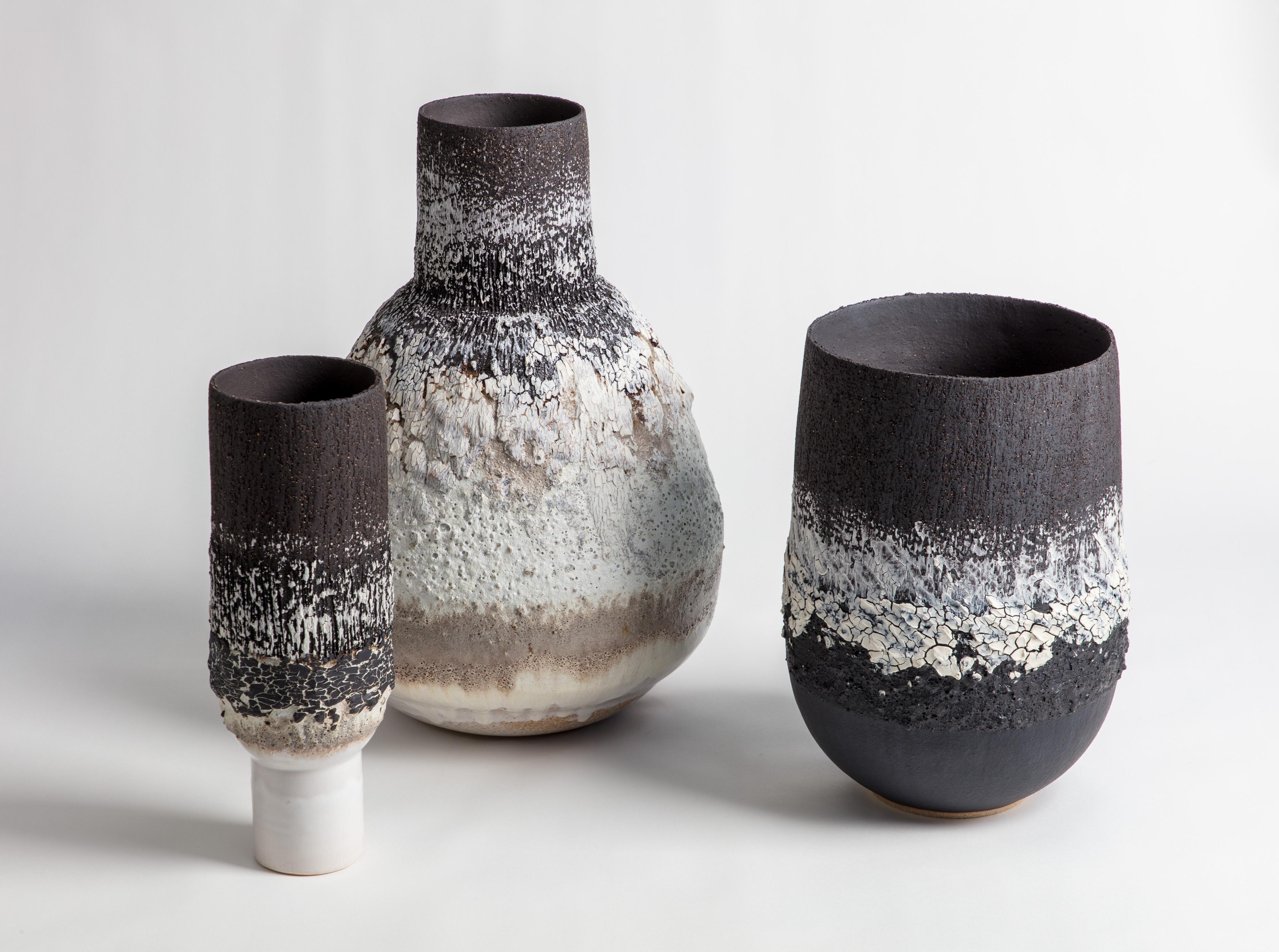 A large bubble texture open vessel with black and white glaze and markings. Made from black textured stoneware clay and porcelain engobe.

Inspiration for the piece comes from the clay itself and the chemical relationships that glaze and volcanic