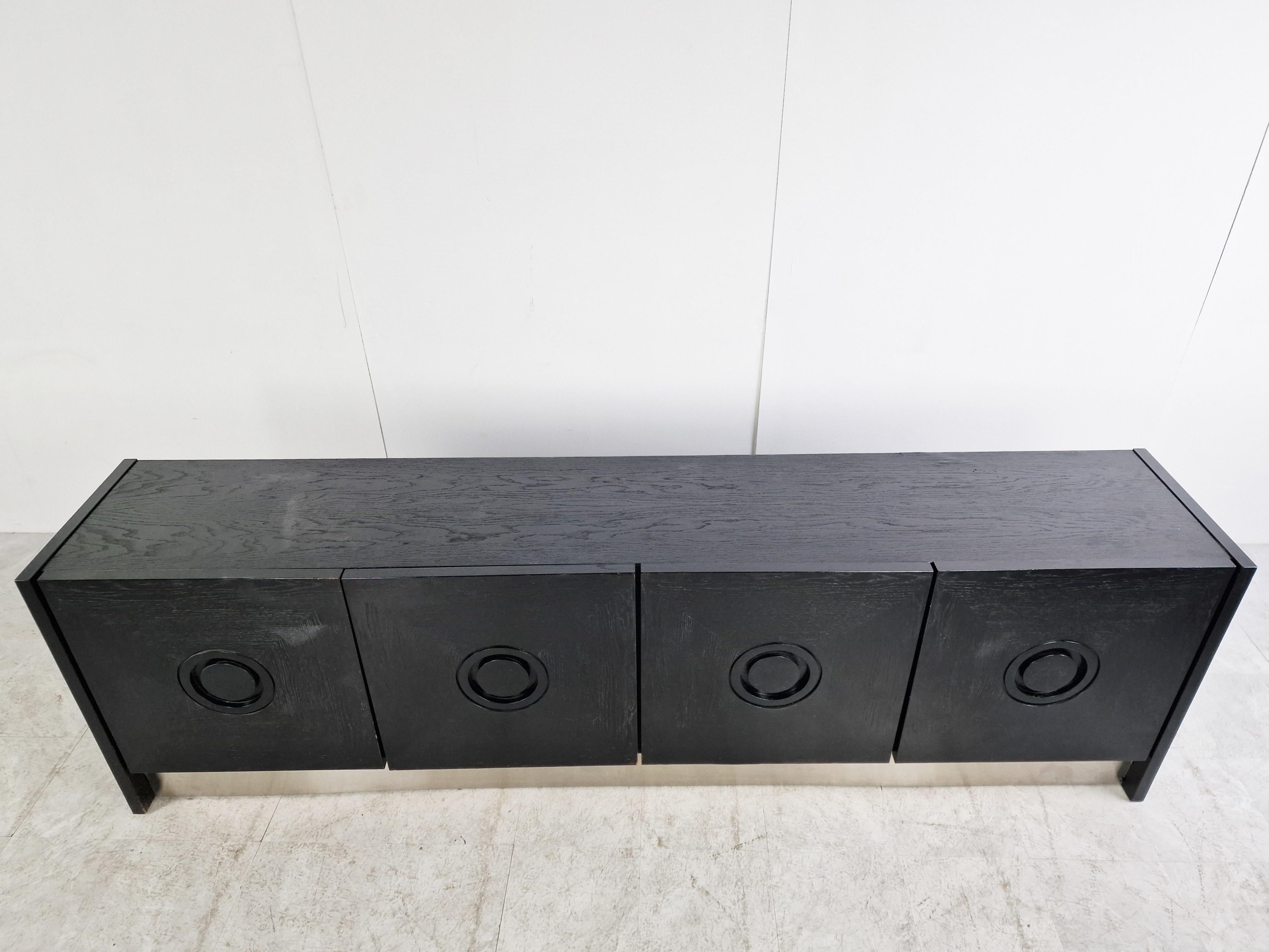 Ebonized black brutalist credenza with 4 graphical doors.

Beautiful timeless design.

Good condition.

1970s - Belgium

Dimensions:

Lenght: 250cm/98.42