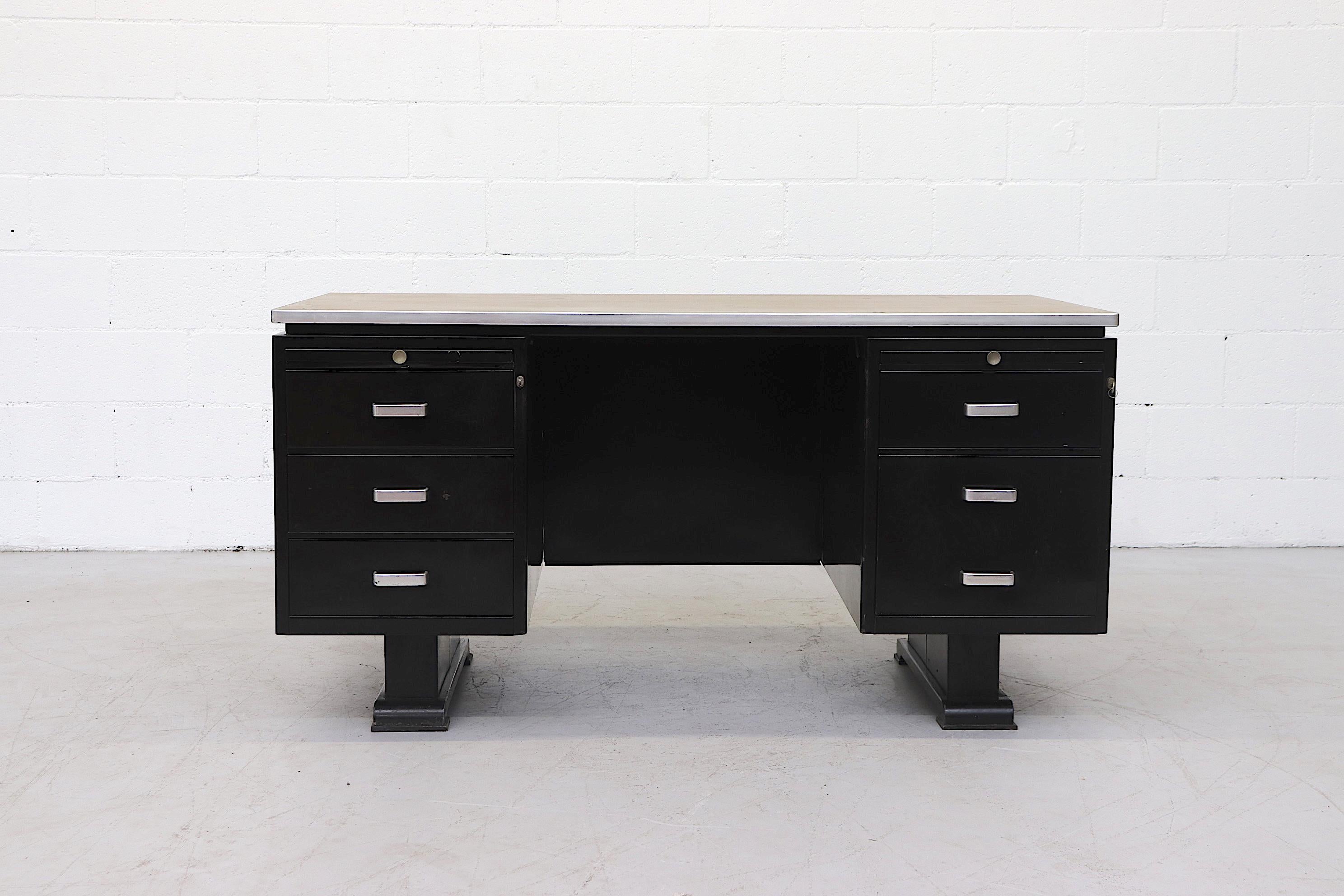 Vintage large black enameled industrial desk by Van Blerk Tilburg, with tan linoleum top and 6 drawers. Executive style desk with built in document trays and aluminum handles. In very original condition with visible scratches and dents consistent