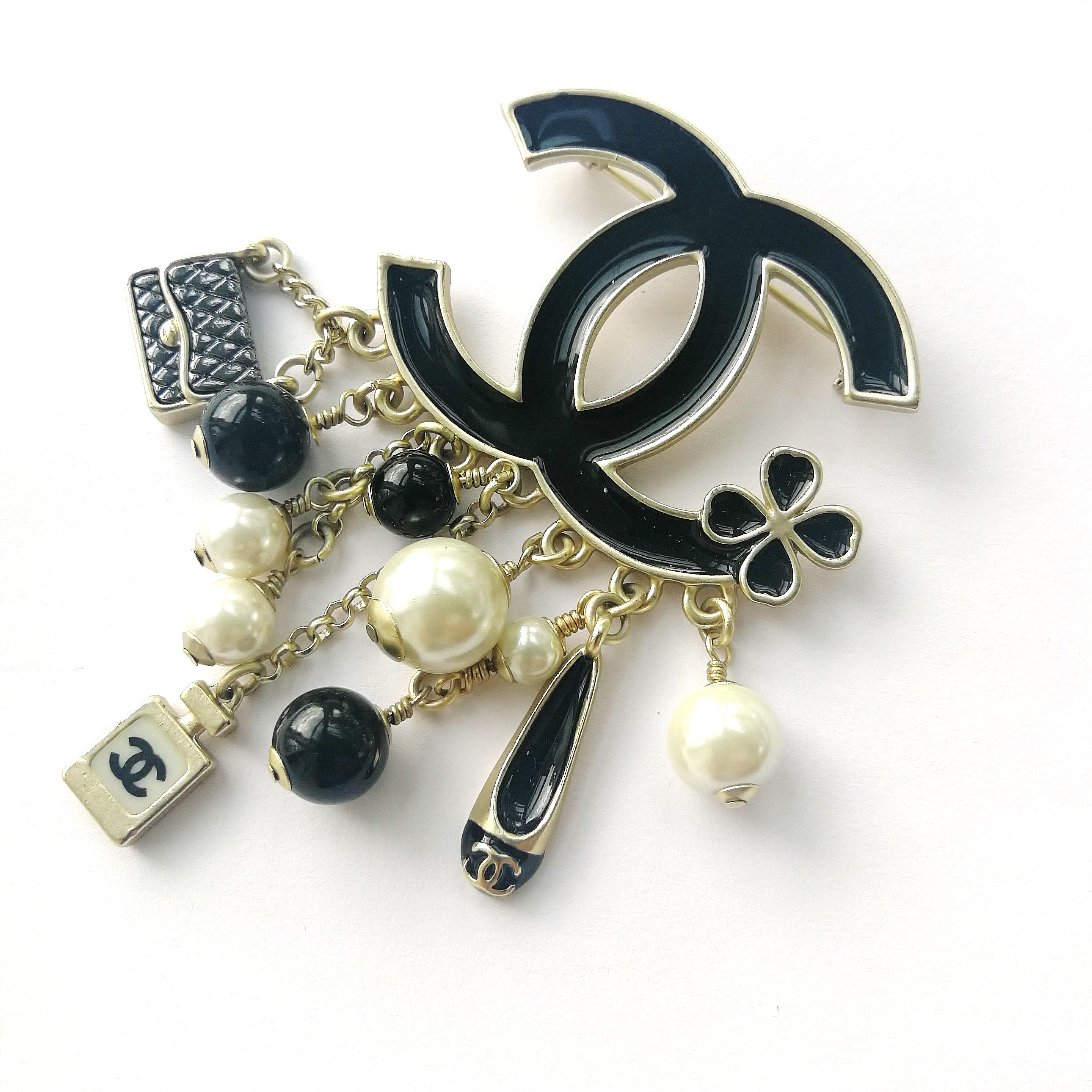 Created for the Autumn 2014 collection, this brooch full of iconic Chanel charms so characteristic of Chanel creations in the last decade or so, is such a Chanel classic.
Made by Desrues, the current maker of Chanel jewellery, the charms of the