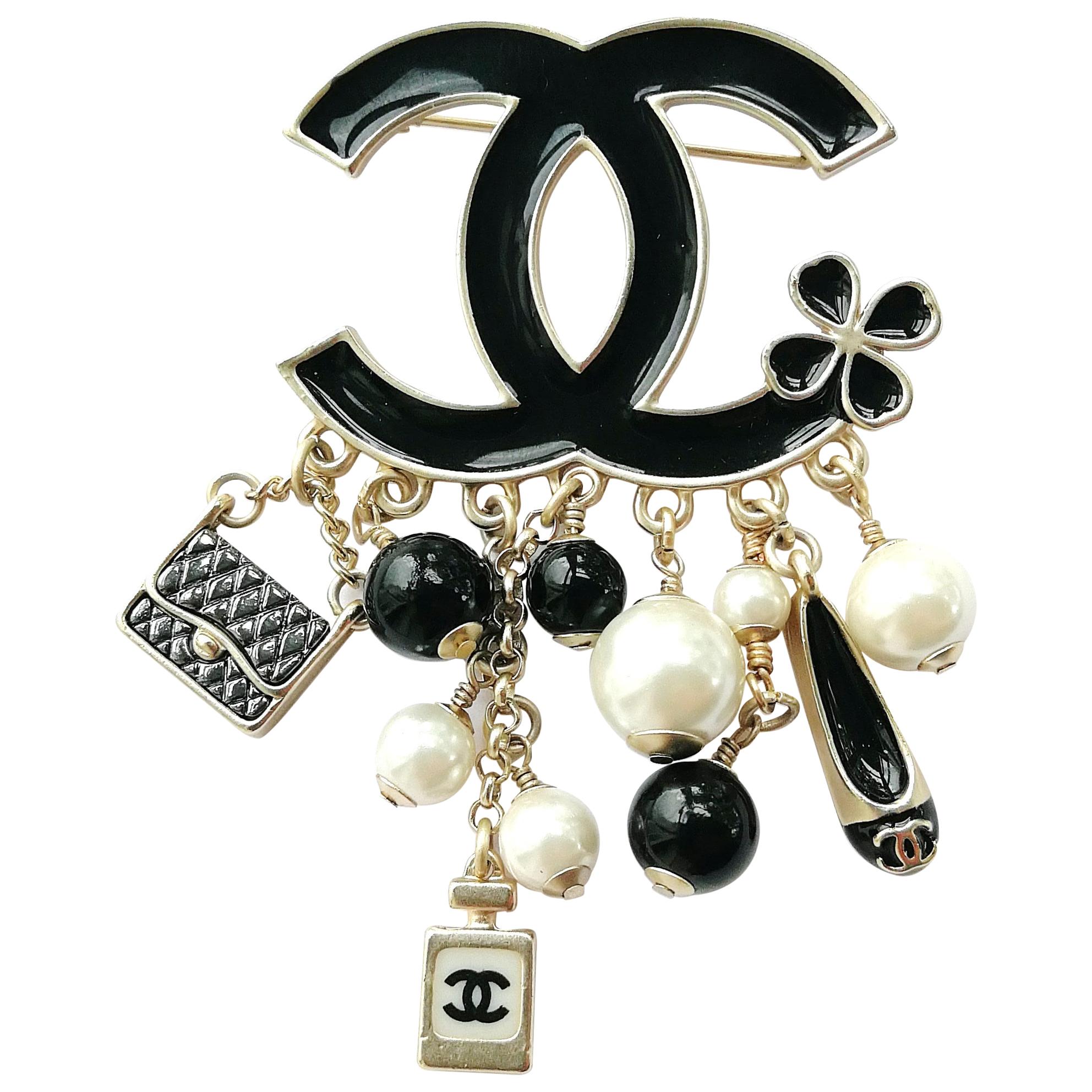 Resin, Enamel and Ruthenium Metal Pin brooch featuring polish coloured  beads and a silver chain charm with classic Chanel logo pendents. Chanel.  2012., Handbags and Accessories Online, Ecommerce Retail